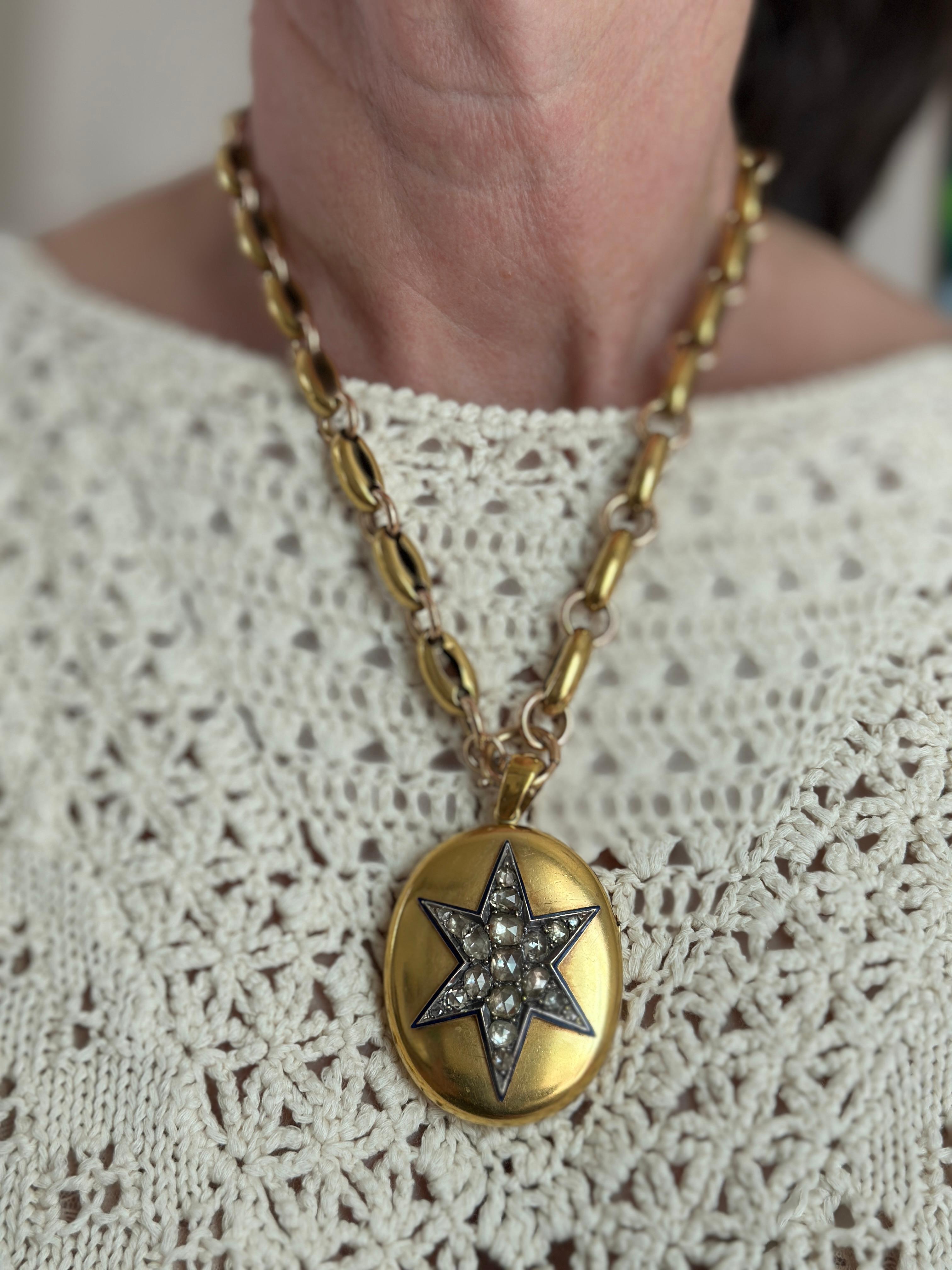 Details:
Absolutely stunning Victorian Enamel Diamond Star mourning locket in 18K yellow gold, and heavy Victorian 14K gold chain. The locket has a star made up of 19 diamonds and surrounded by dark blue enamel. The diamonds are old rose cut