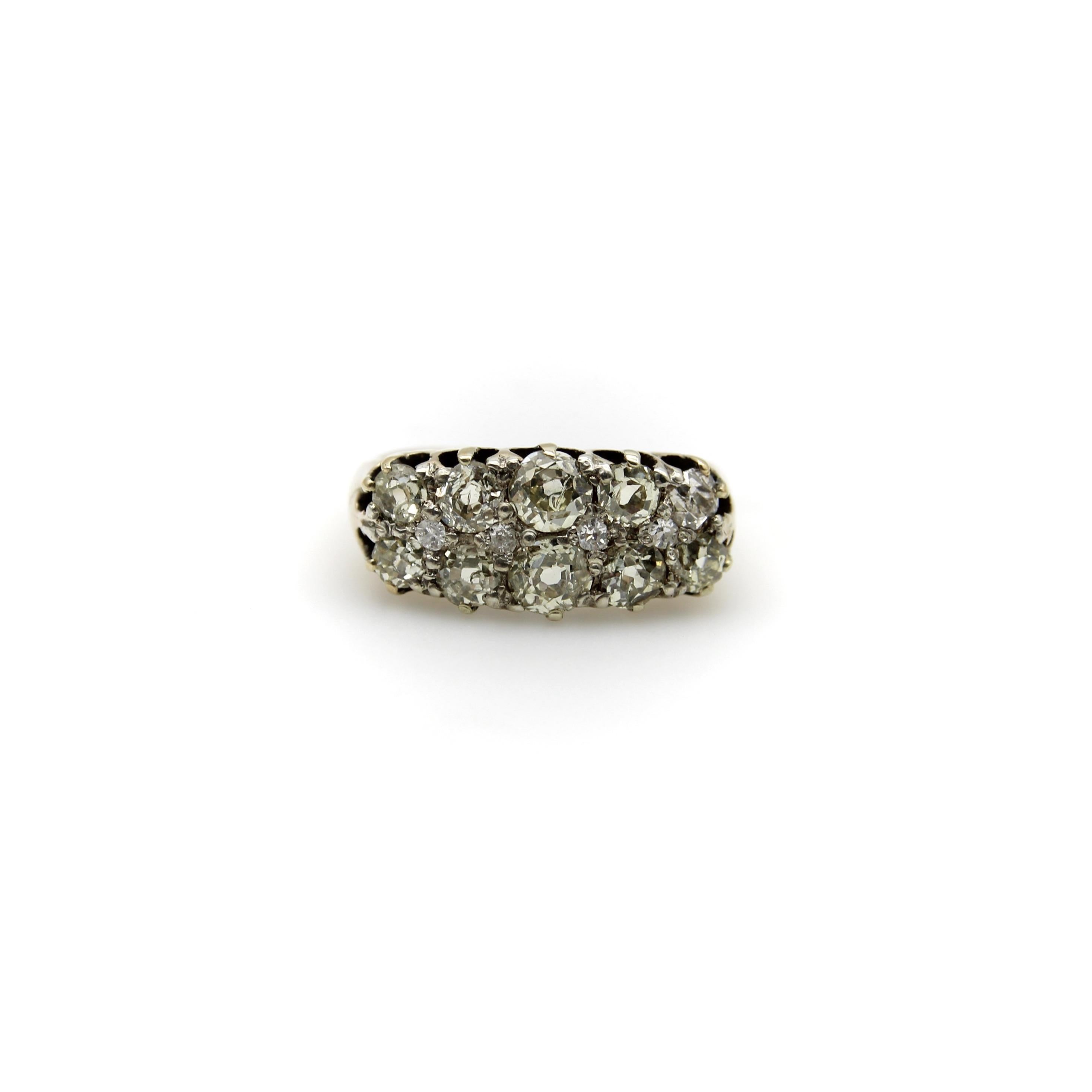 This spectacular Old Mine Cut diamond ring presents a wide band of encrusted diamond sparkle comprised of Old Mine Cut and Single Cut diamonds that are bead set to appear as a myriad of wonderful facets. When viewed from the side, the ring has a