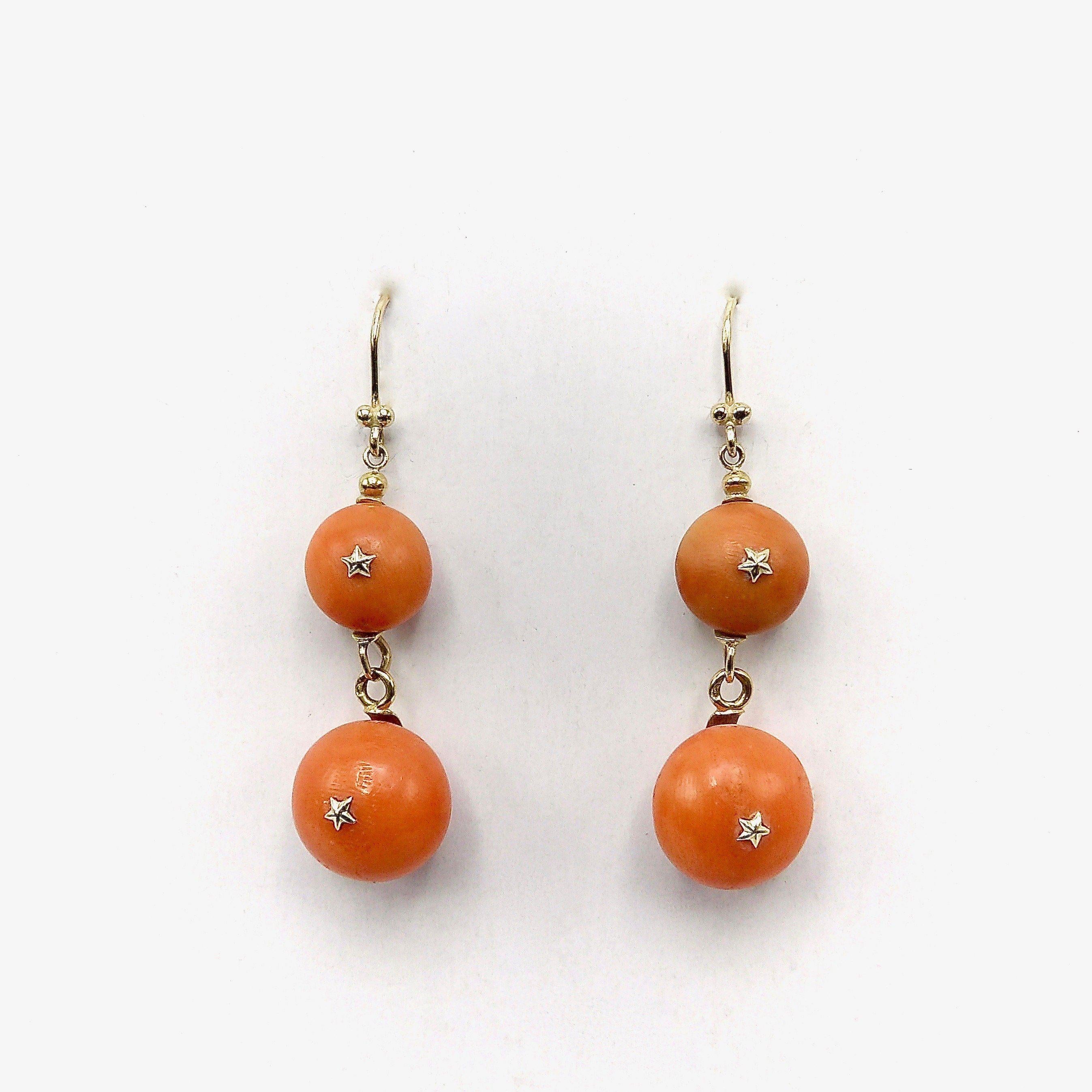 Victorian 18K Gold French Coral Ball Dangle Earrings, 1870
 
These beautiful French coral ball dangle earrings remind one of a summers day. Two graduated slightly flattened balls dangle from a Euro wire like ripe melon balls luscious and sweet. The