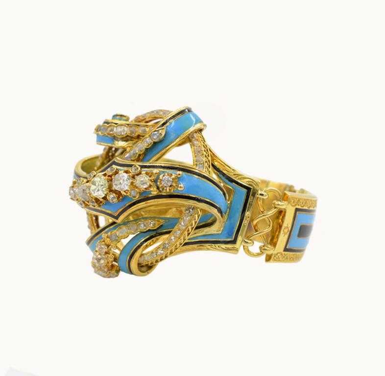 Victorian antique 18 karat yellow gold link bracelet from circa 1850.  The bracelet looks like a stylized lover's knot and is decorated with beautiful black and Robin's Egg blue enamel throughout.  

The center of the knot features an approximate