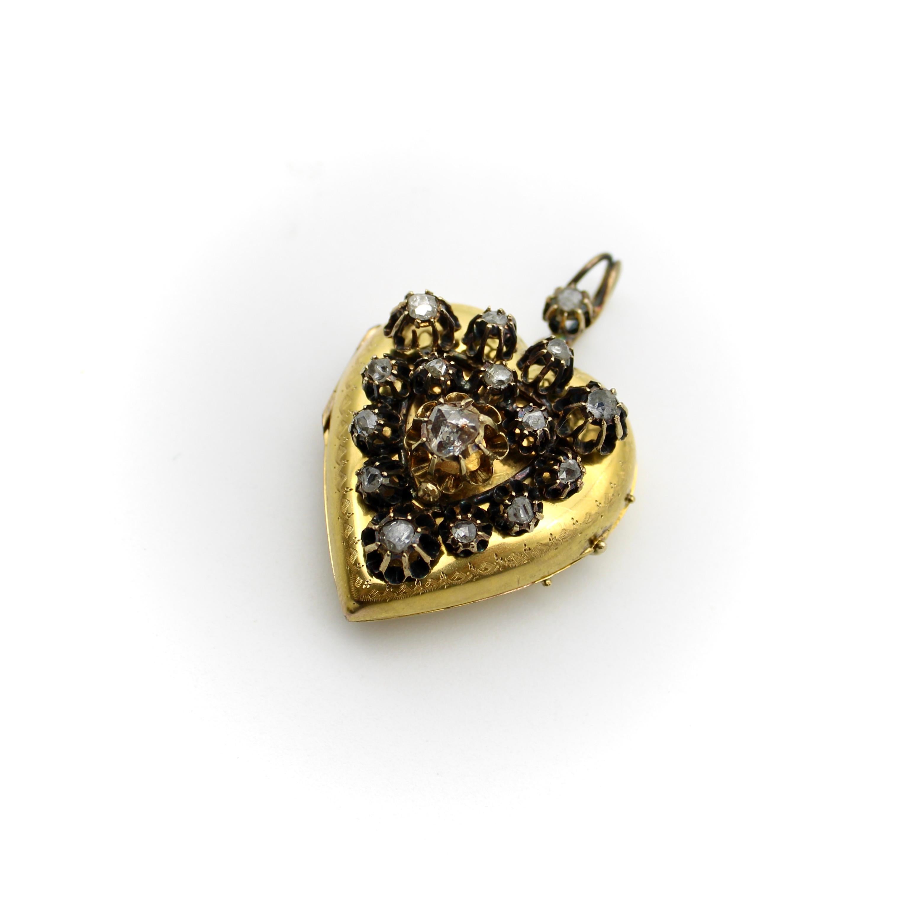 Circa 1880, this heart shaped locket is encrusted with rose cut diamonds, held up by tall buttercup prongs. The prongs are connected as a mount, separate from the locket, which has been riveted onto the piece. The dark patina of the mount creates an