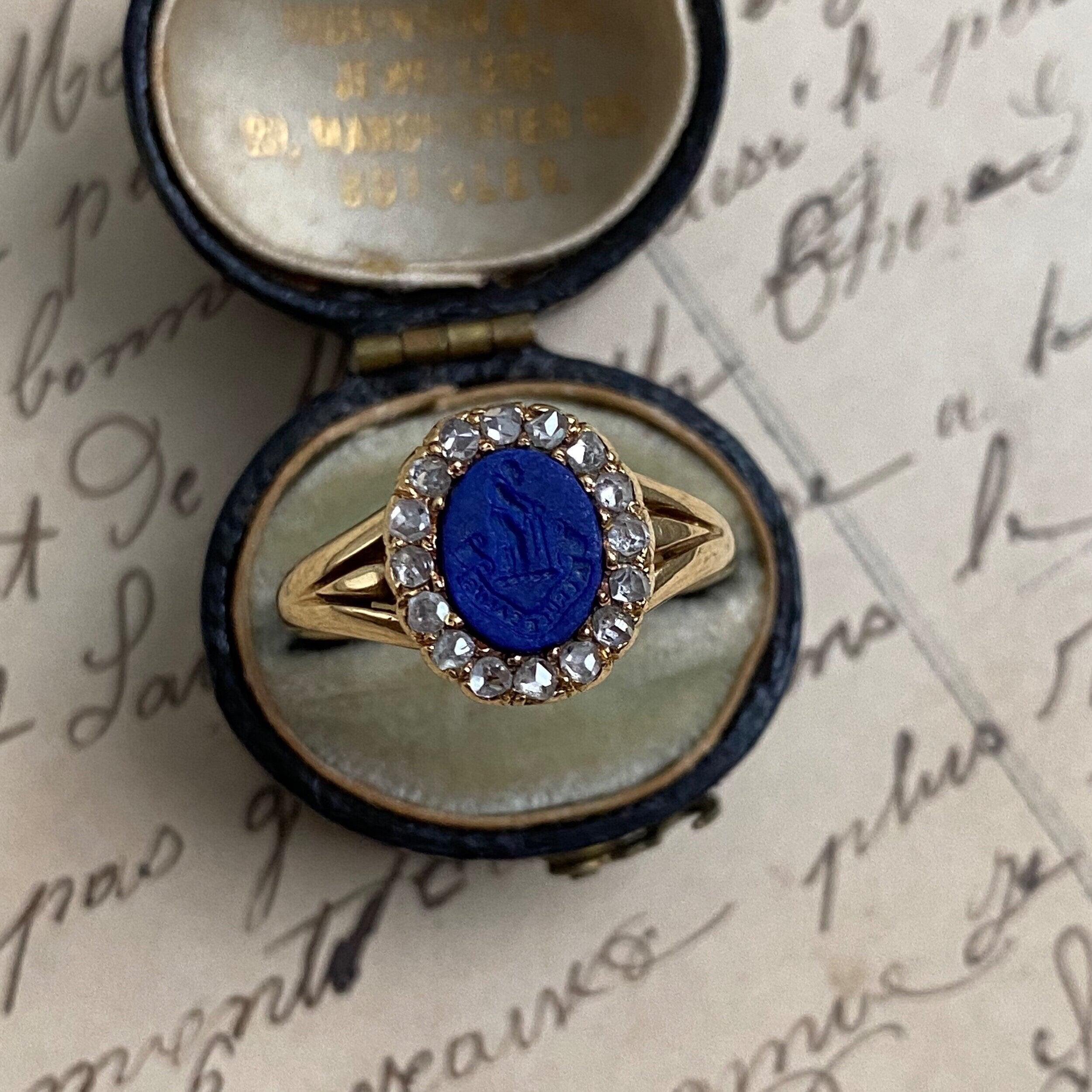 18K Lapis Intaglio Ring with Rose Cut Diamond Surround
“A Cruce Salus” “From the Cross Comes Salvation”

Size: 7

Measurements: 11.4 mm north to south

Weight: 3.3 grams

Notes: The antique box shown is for photography purposes. All jewelry will be