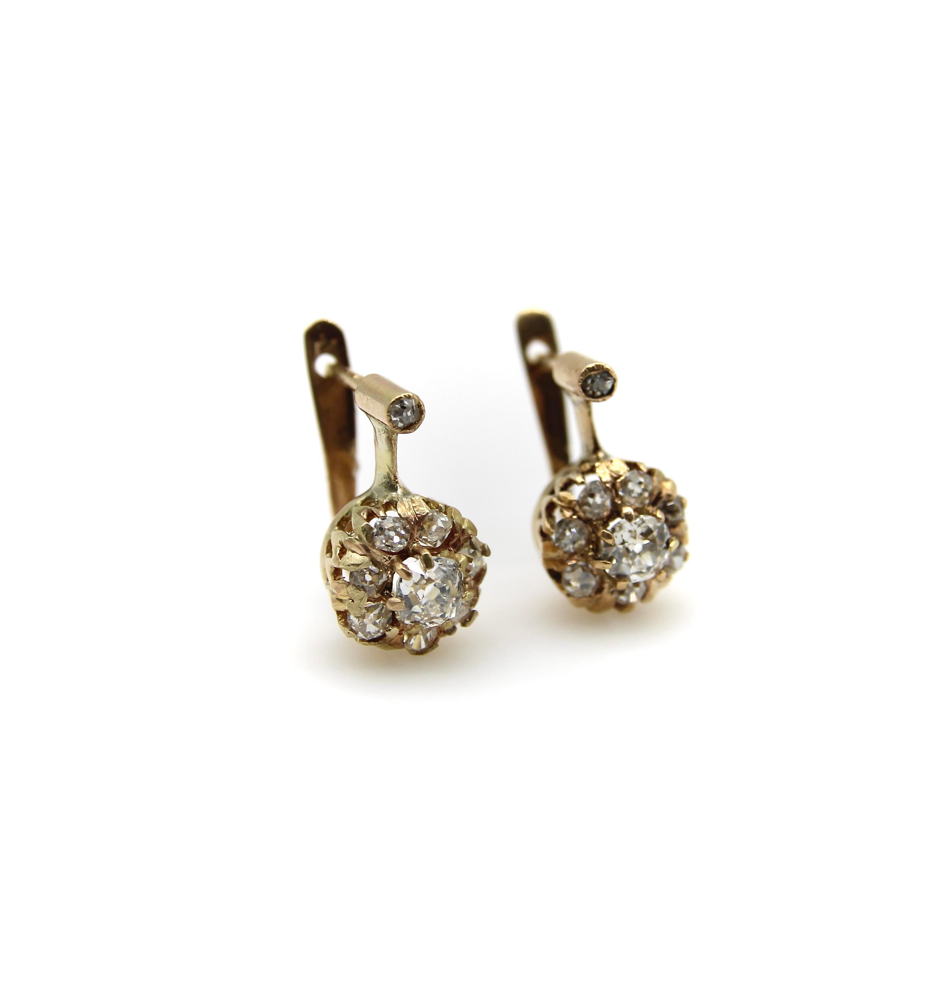 These delicately crafted 18k gold Victorian earrings feature Old Mine Cut diamonds carefully prong set into the shape of a flower. Combined, these sparkly earrings contain over a carat of diamonds, and the handcrafted details of these earrings make