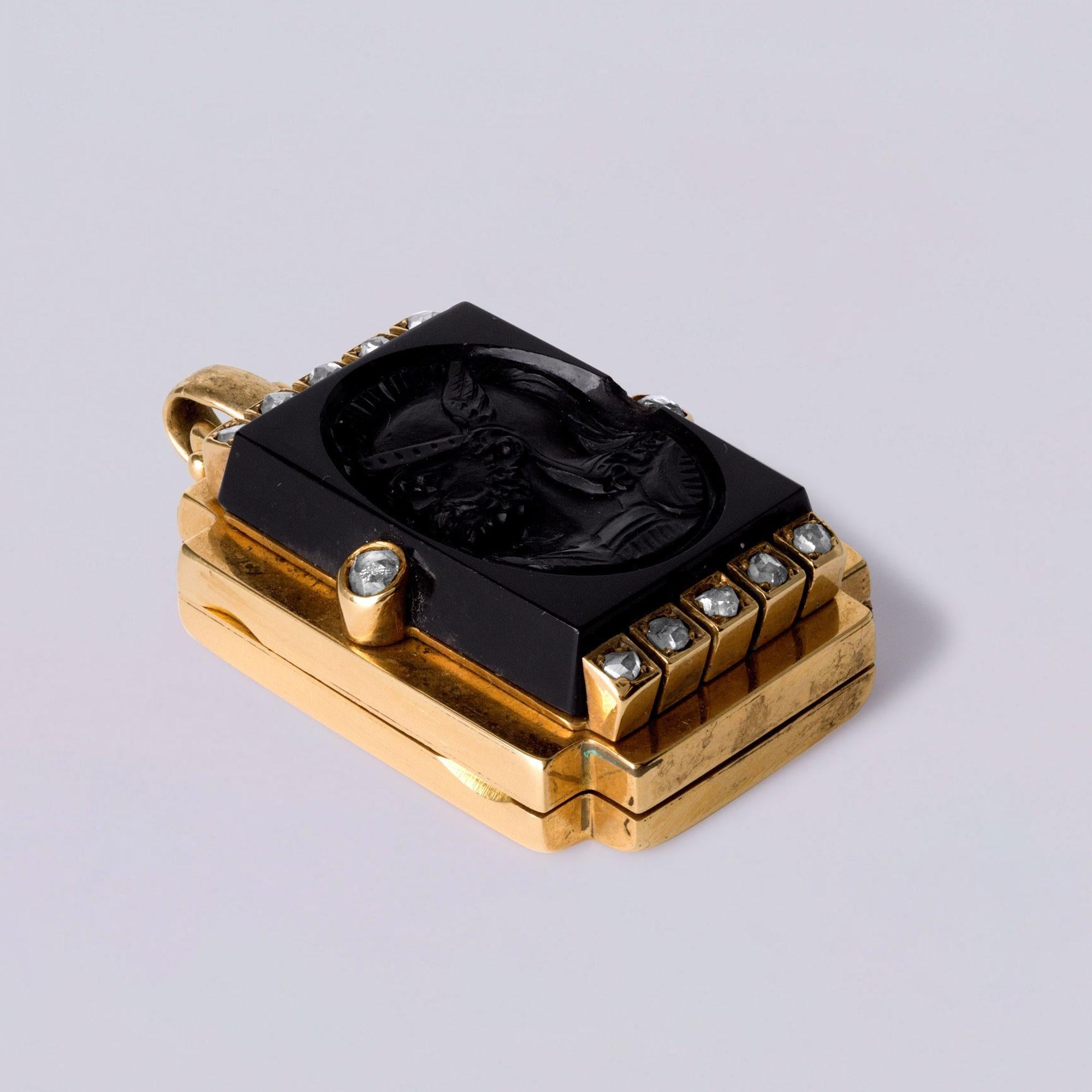 This striking Victorian-era locket pendant, circa 1885, showcases a masterfully hand-carved jet hardstone cameo of a helmeted soldier, elegantly bezel-set in rich 18K rose gold. The piece is adorned with 12 rose cut diamond accents, adding a soft,
