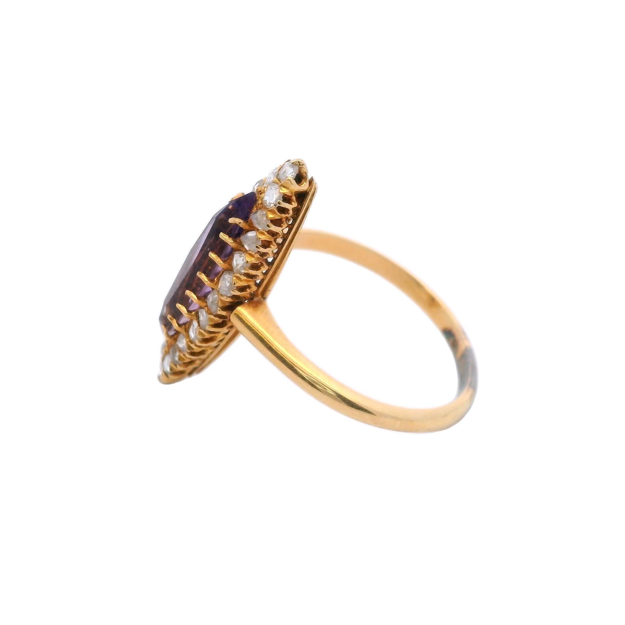 Experience the timeless beauty of the Victorian era with this stunning 18K Yellow Gold Amethyst and Rose Cut Diamond Navette Ring. At its heart, a 0.85-carat marquise-cut amethyst radiates a deep, rich purple hue, evoking both elegance and