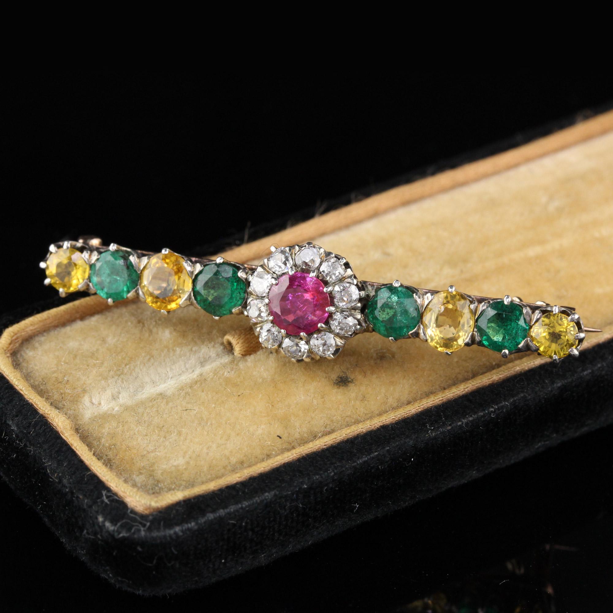 A playful & beautiful Victorian bar brooch with emeralds, yellow sapphires and a Burmese Ruby surrounded by a halo of old cut diamonds in the center!

Metal: 18K Yellow Gold

Weight: 5.8 Grams

Diamond Weight: Approximately 0.30 cts

Diamond Color: