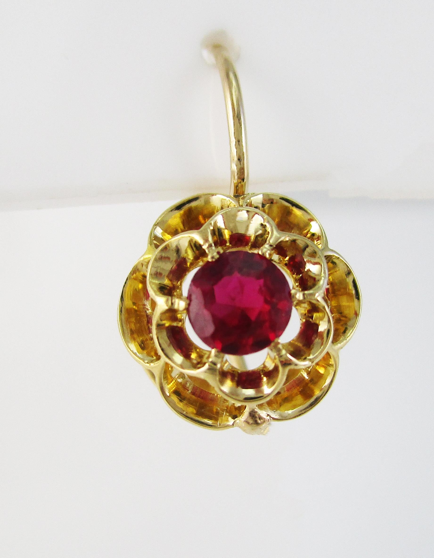 These gorgeous Victorian earrings are in 18k yellow gold and are a lovely floral dangle design featuring ruby center stones! The combination of yellow gold and red ruby is a classic Victorian look that is timeless and elegant! The red rubies are set