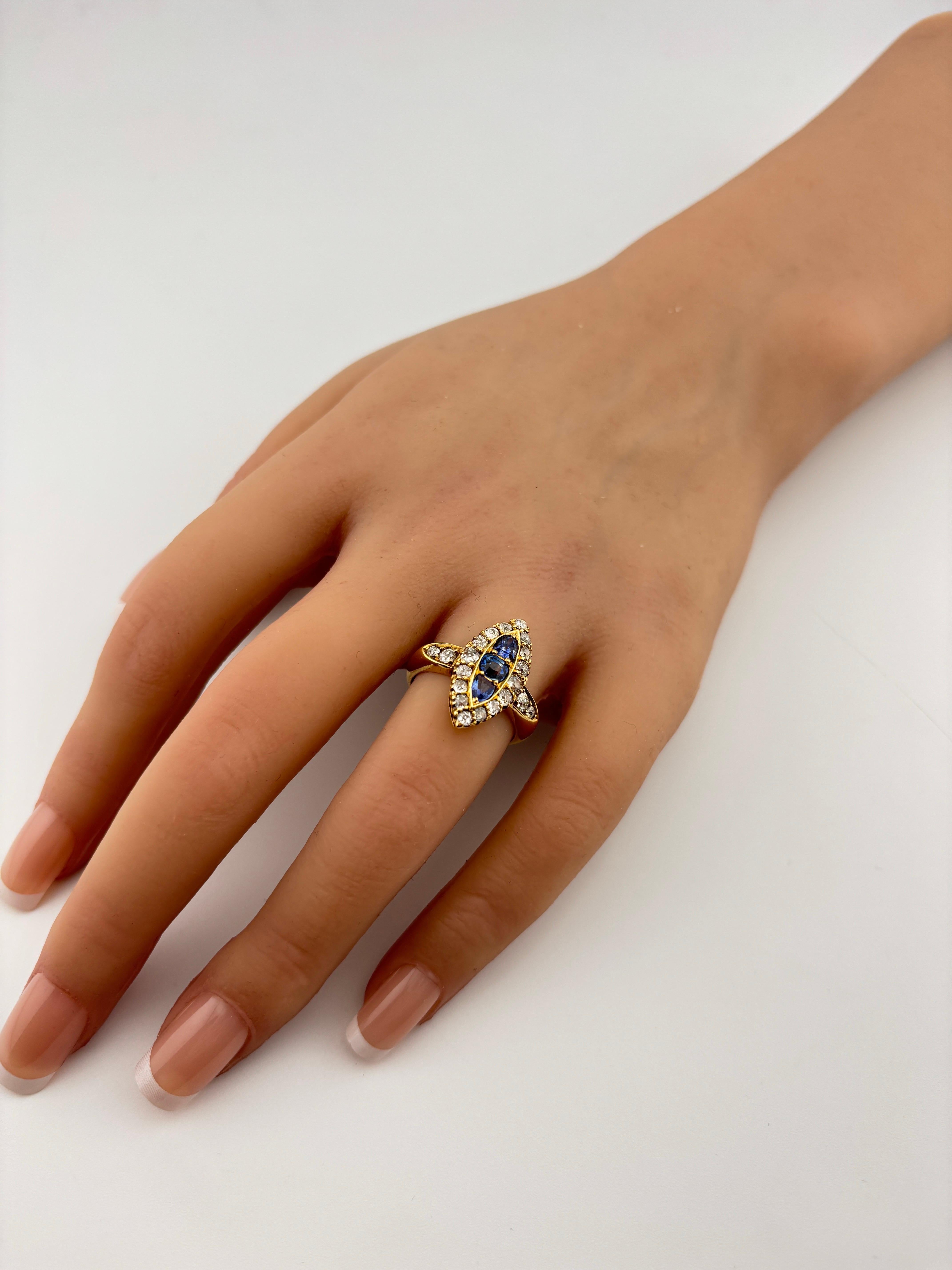 This ring is opulent yet romantic, with a distinct antique charm. The combination of sapphires and diamonds provides a striking contrast against the 18k gold, and the elongated navette shape creates a sophisticated, flattering look on the finger. 