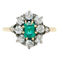 Victorian 18K Gold and Silver and 1.0 Carat Emerald and 1.50 Carat Diamond Halo