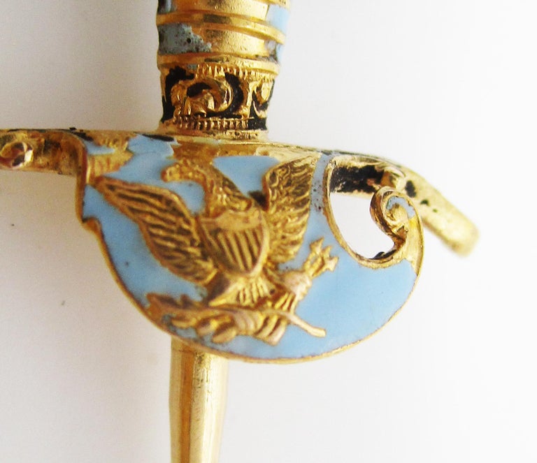This is a fantastic Victorian hat stick pin in 18k yellow gold with gorgeous pale blue enamel detailing. The pin is in the design of a long sword and would have once been used by a fine lady to pin her hat! The hilt of the sword is decorated with