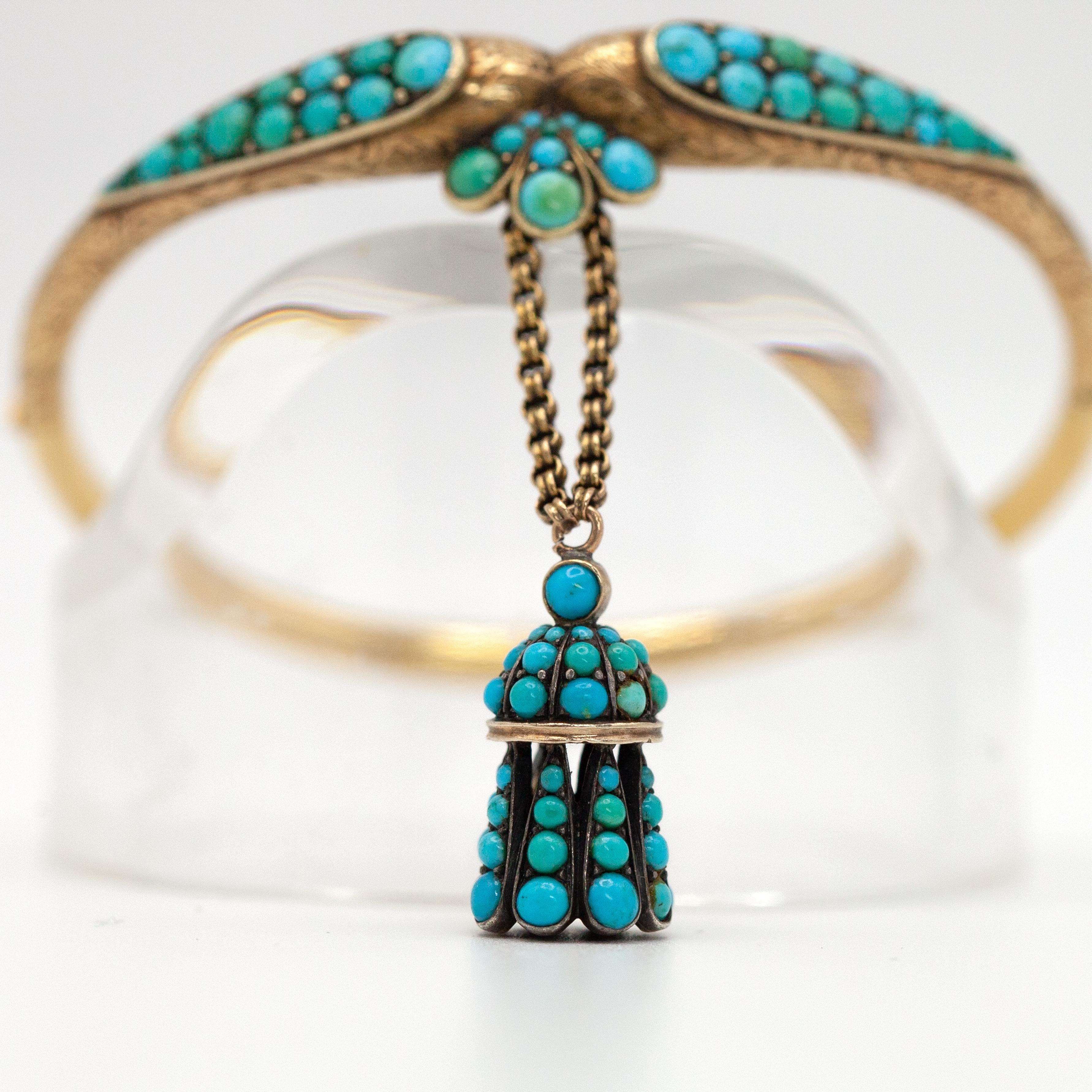 Rare and exquisite Victorian cabochon turquoise hinged engraving bangle crafted in 18K yellow gold with a turquoise charm

Approximate Weight: 15.8grams

Approximate Measurements:
Fits up to 6.25” wrist
Inner - 55.6mm x 48.2mm
Outer - 62mm x 56.7mm