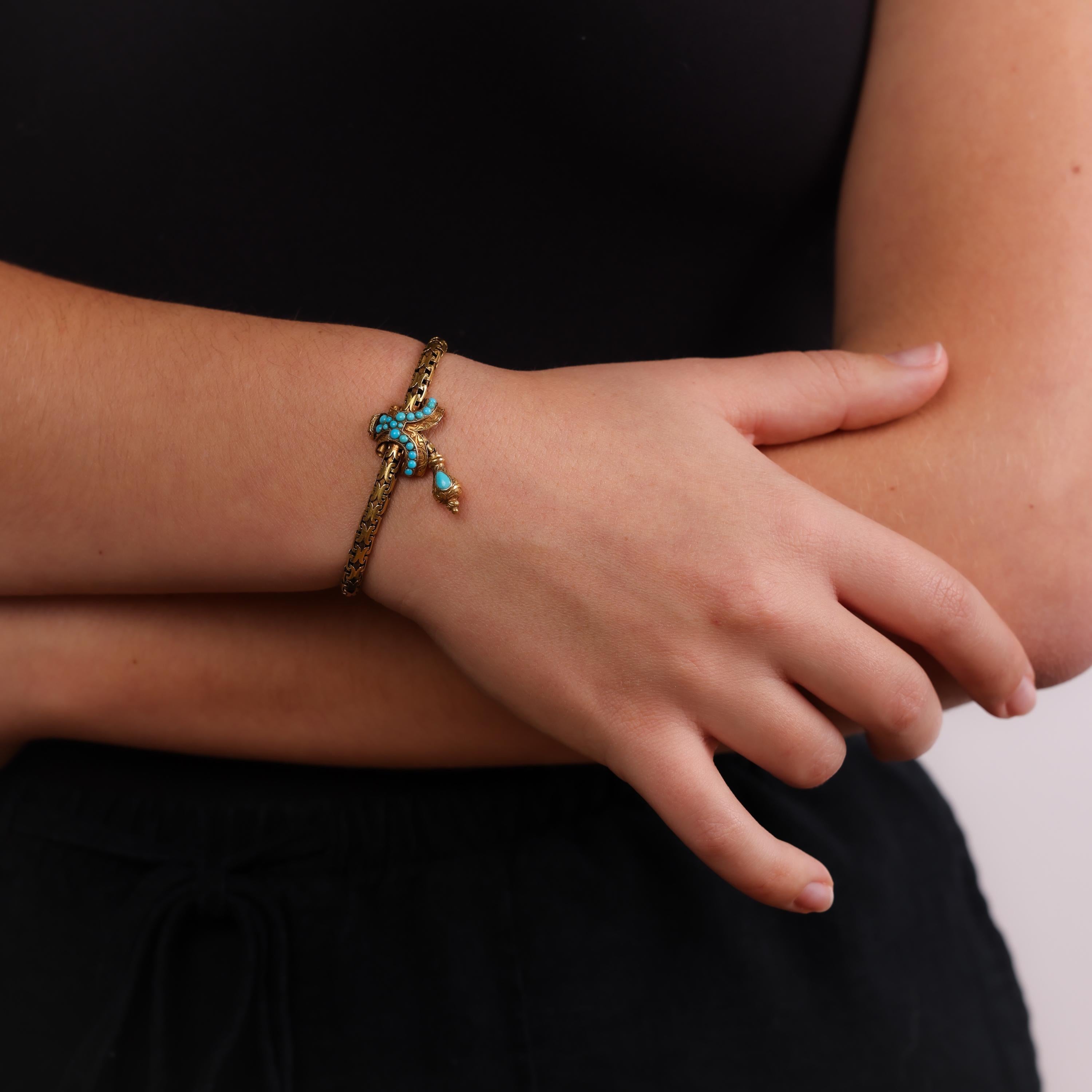 This Victorian 18k yellow gold bracelet showcases 21 luminous cabochon-cut turquoise stones, offering a timeless and elegant design with historical charm from the 1860s.

Center stone: 21 cabochon cut turquoise 
Metal: 18k yellow gold 
Era: