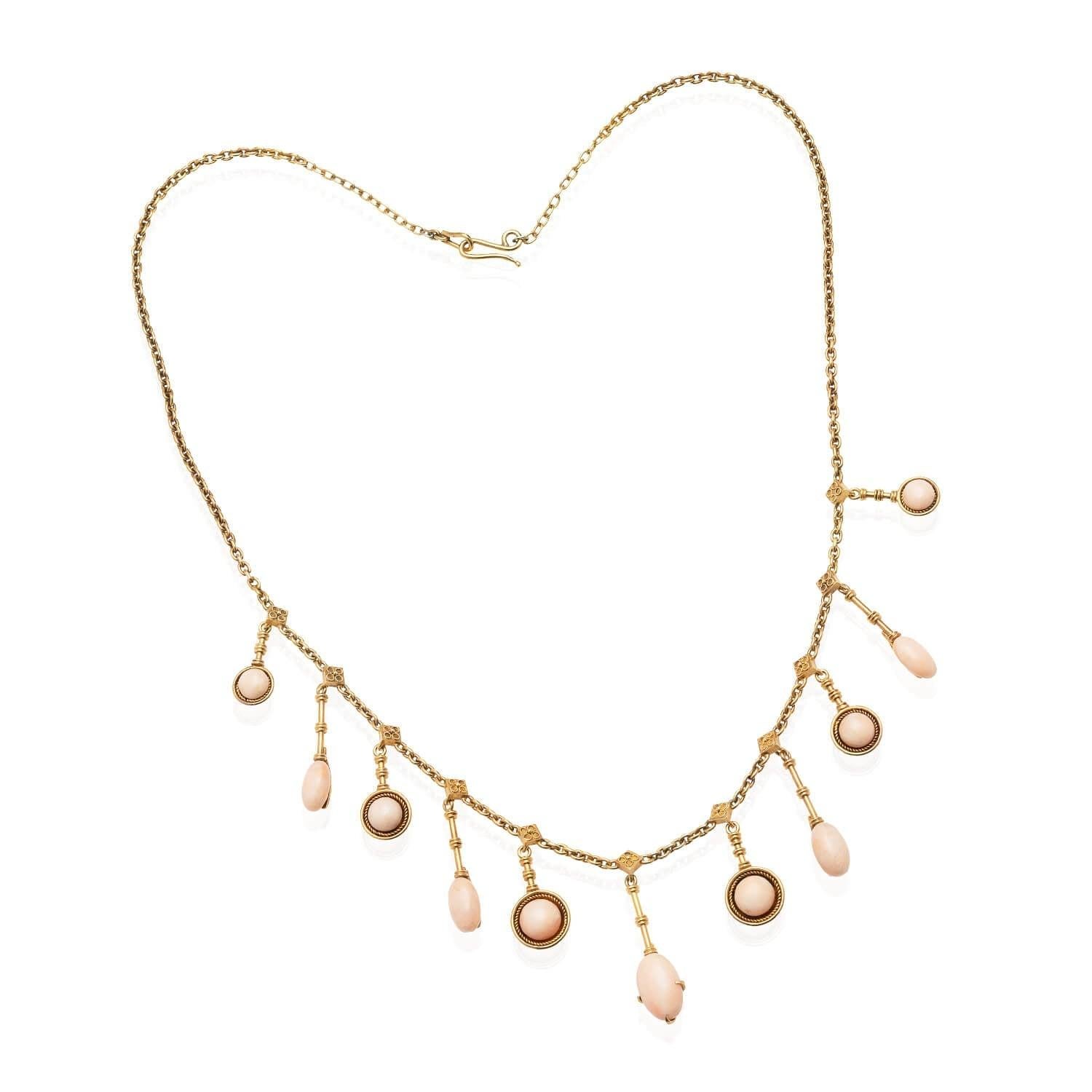 A lovely necklace from the Victorian (ca1880s) era! Crafted in 18kt yellow gold, this necklace features beautiful light pink Angel Skin coral. Hanging from detailed diamond-shaped settings, this festoon-style necklace alternates between round coral