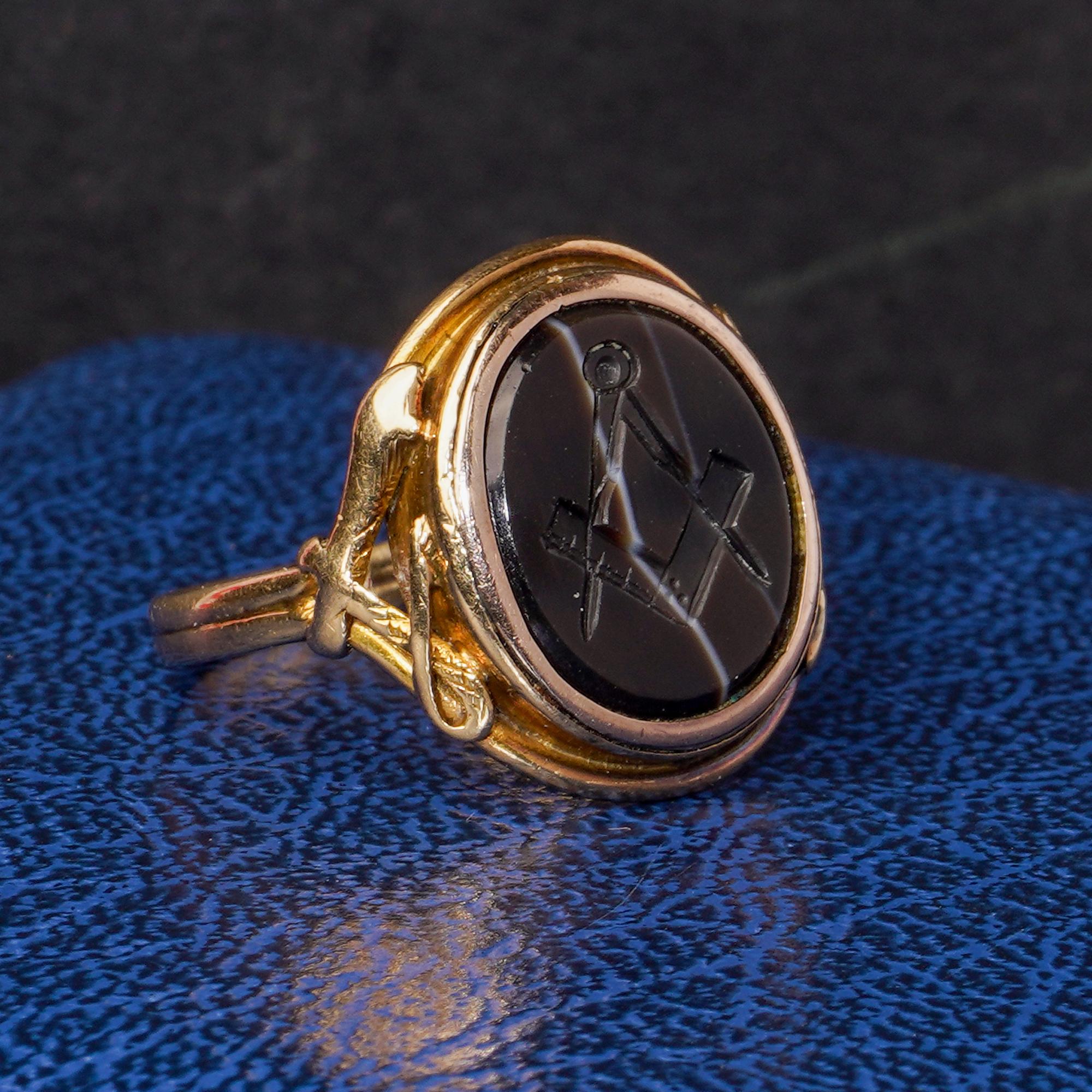 Antique Victorian 18kt. yellow gold Banded agate masonic signet ring, depicting a Square and Compass.
Made in England, Circa 1870's
X - Ray tested positive for 18kt. gold.

While there are many symbols associated with Freemasonry, none are more