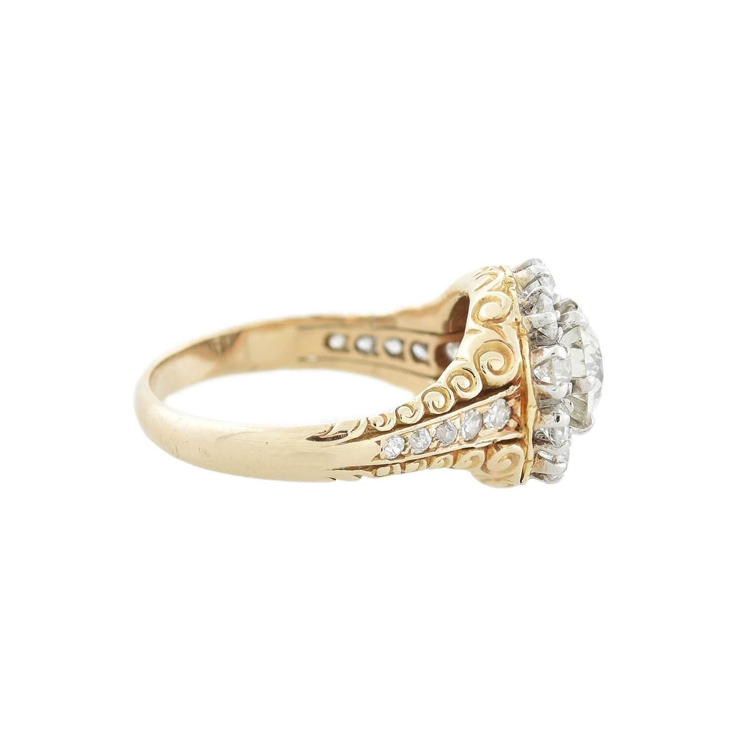 A gorgeous diamond cluster ring from the Victorian (ca1890s) era! This exquisite ring is made of vibrant 18kt yellow gold topped in sterling silver. A sparkling 0.95ctw Old European Cut diamond of H/I color and VS1-VS2 clarity is surrounded by ten