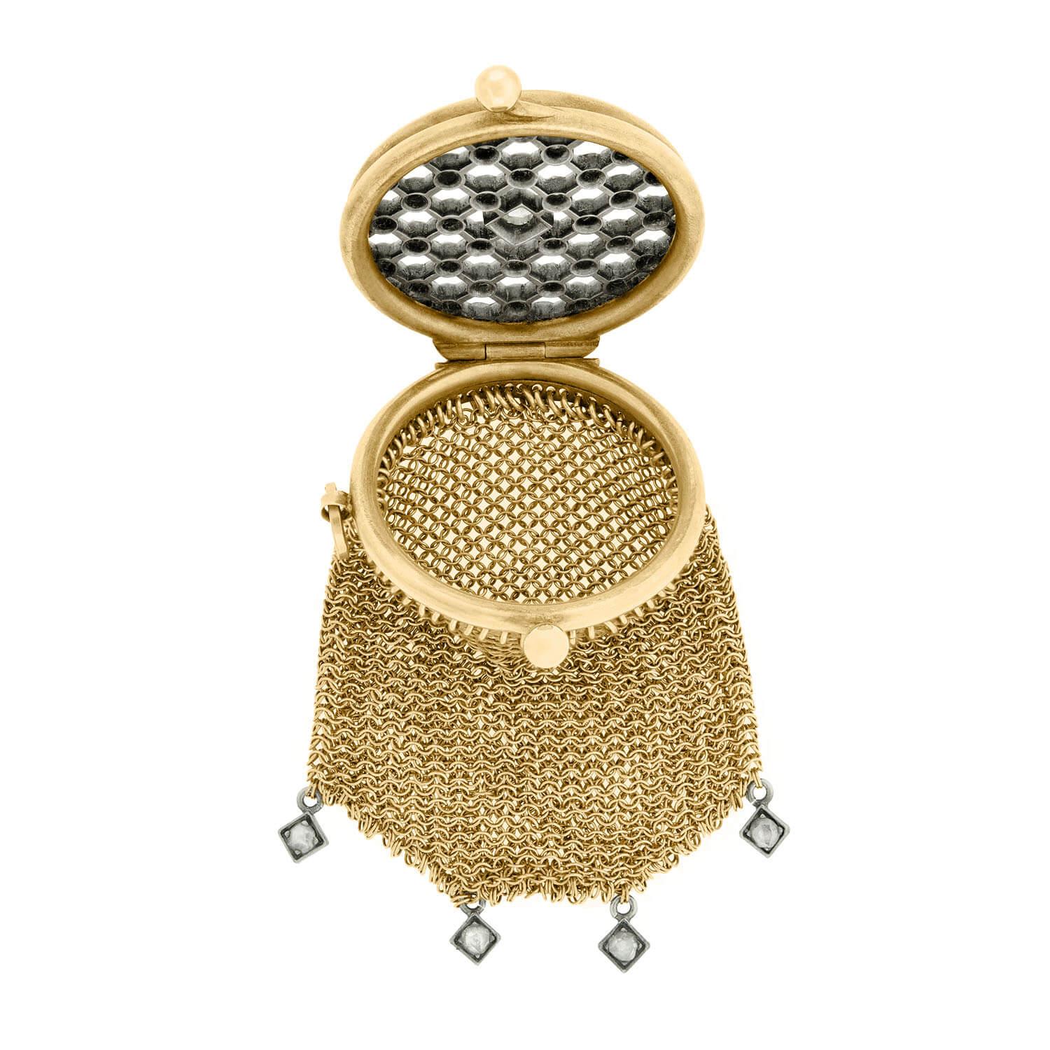 An absolutely gorgeous and unique chatelaine purse from the Victorian (ca1880) era! Crafted in solid 14kt yellow gold and sterling silver, this ornate coin purse features a beautiful frame that holds a hand wrought mesh bag. The circular gold frame