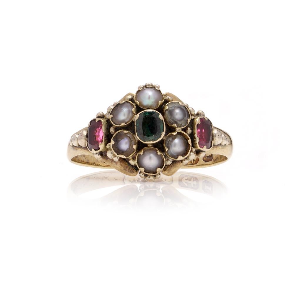 Victorian 18kt yellow gold mourning cluster ring with a central emerald surrounded by 6 seed pearls and two rubies. 
The back of a ring still has an original locket, likely intended for a lock of hair. 
Made in 1857, Birmingham.
Fully hallmarked.