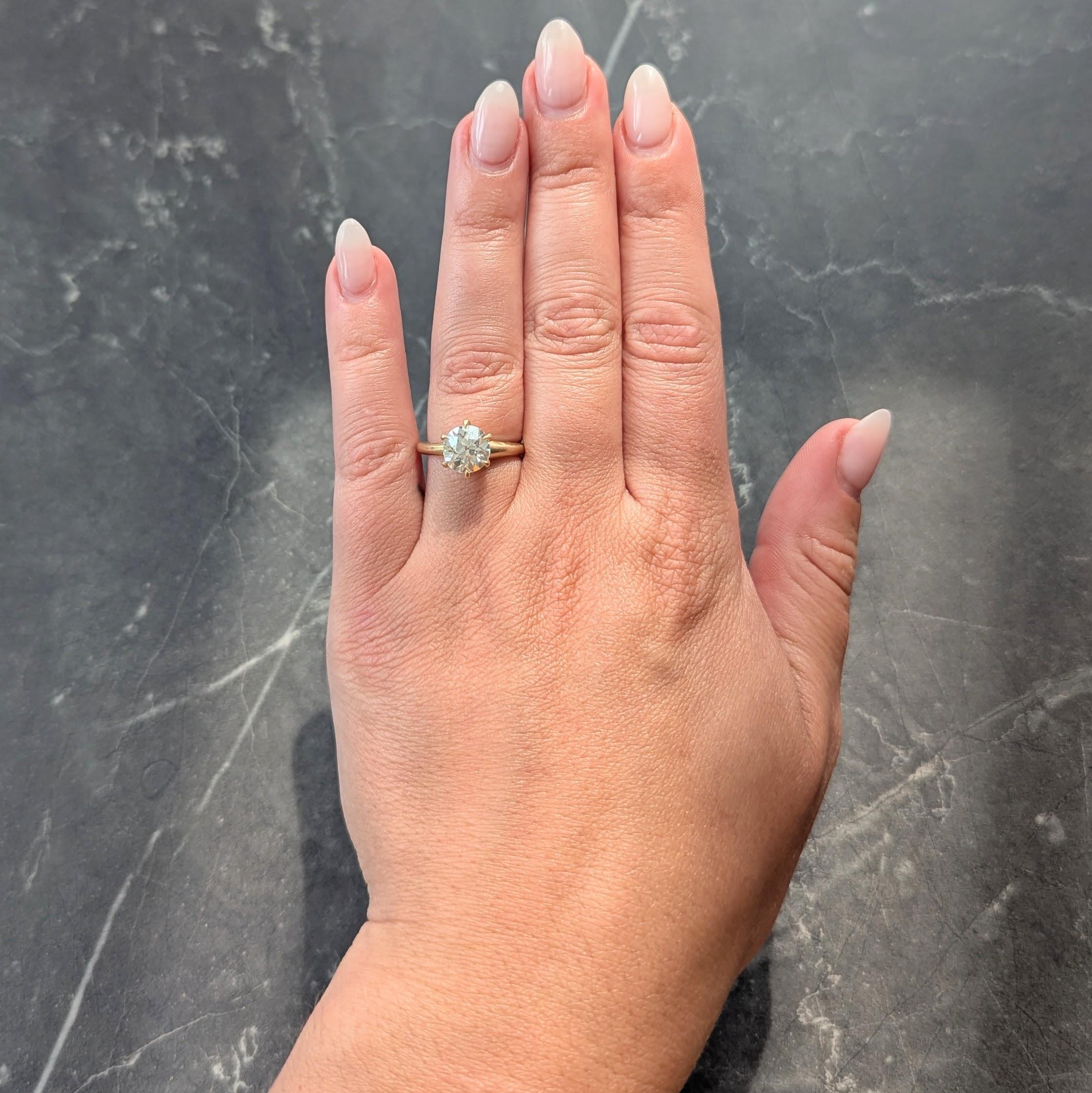 Centering an old European cut diamond weighing 1.96 carats
K color with VS2 clarity - set in a six talon prong mount
Flanked by rounded shoulders
Stamped for 14 karat gold
Circa: 1900
Ring size: 5 3/4 and sizable
Measures north to south 9.5 mm and