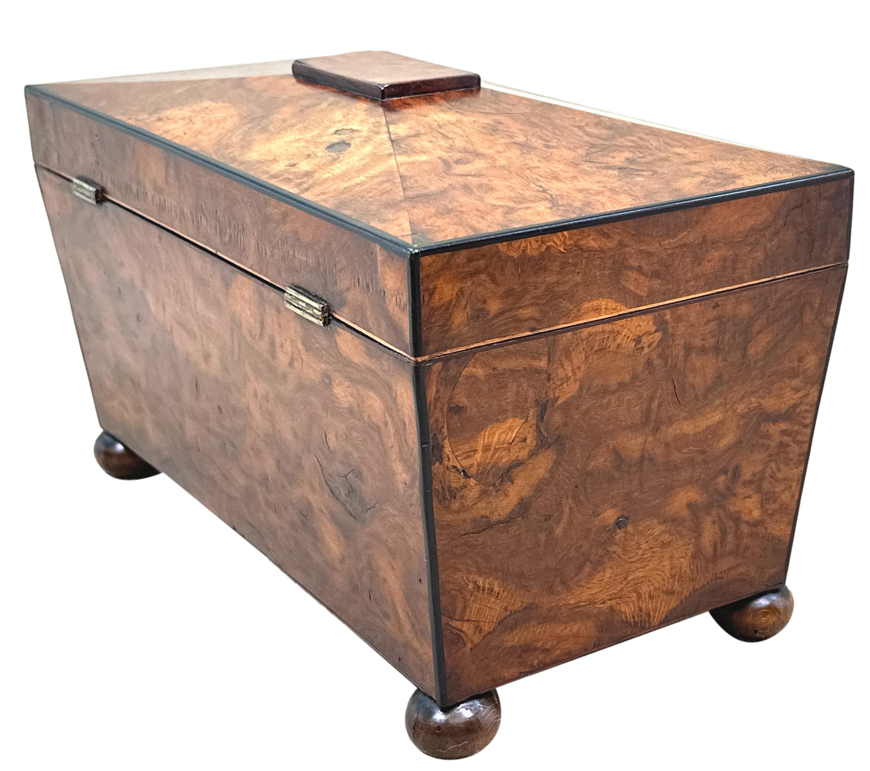 A Good Quality Mid 19th Century Figured Yew Wood Tea Caddy Of Sarchophagus Form Having Well Figured Sides And Hinged Pagoda Top Enclosing Three Sections With Two Removable Canisters, Raised On Original Turned Bun Feet.

An excellent quality 19th