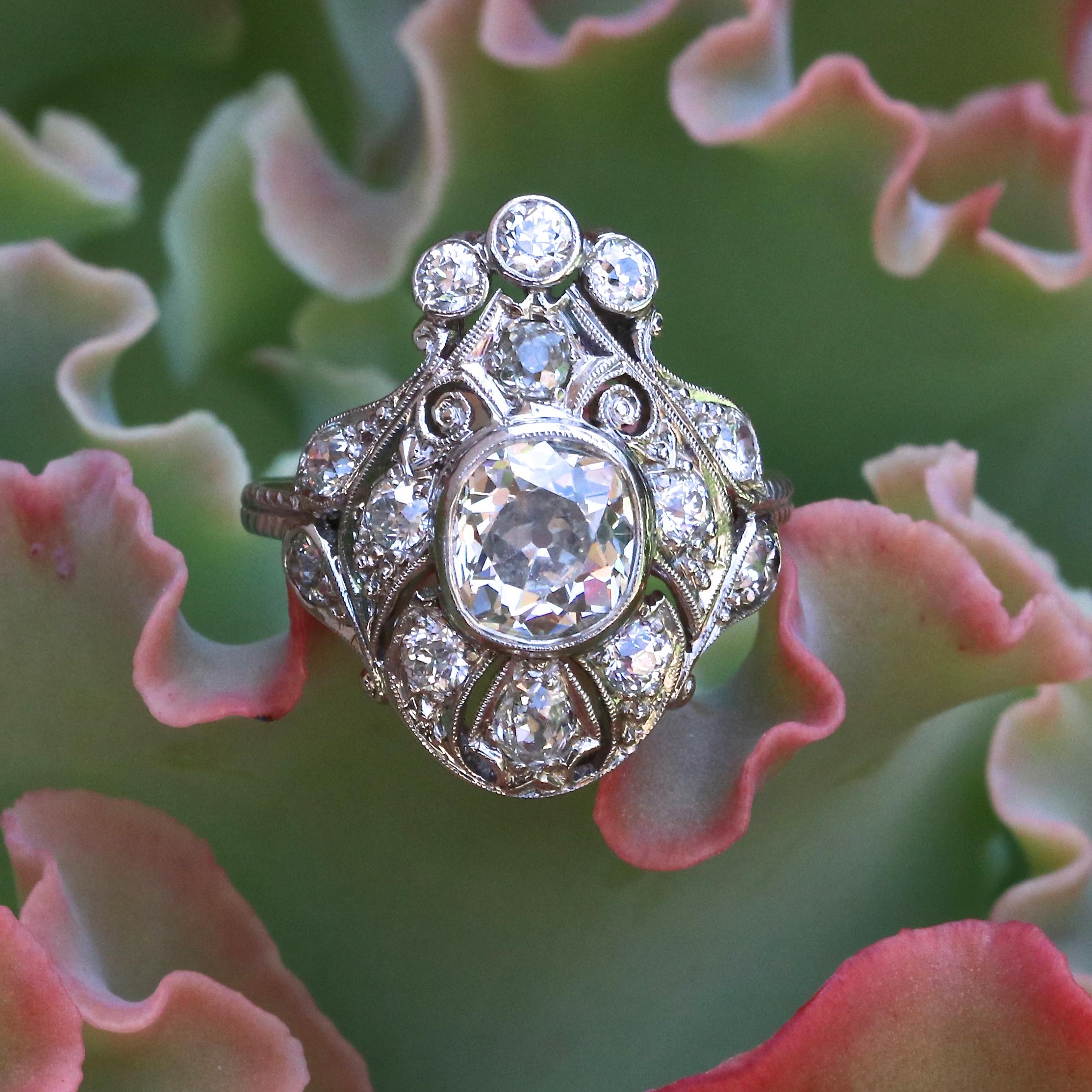 A regal ring from the Victorian era. Our love affair should last this long. Featuring an approximately 2.00 carat old mine cut diamond graded as L color, SI2 clarity. Surrounded by numerous old European cut diamonds weighing approximately  0.50