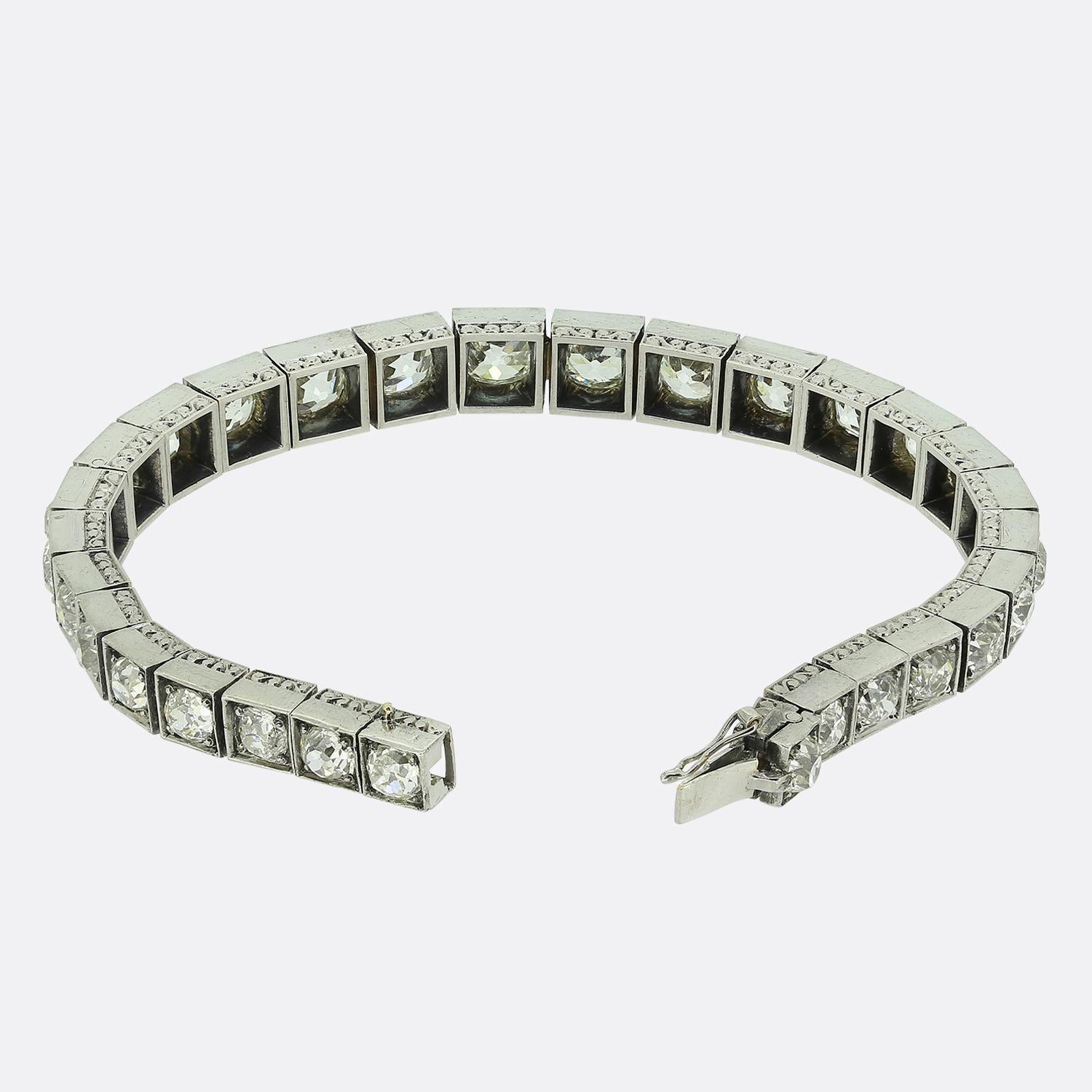 Here we have a chunky 18ct white gold diamond line bracelet crafted during the later stages of the Victorian era. This antique piece features 29 round faceted old mine cut diamonds; each of which has been silver claw set in an individualised boxed