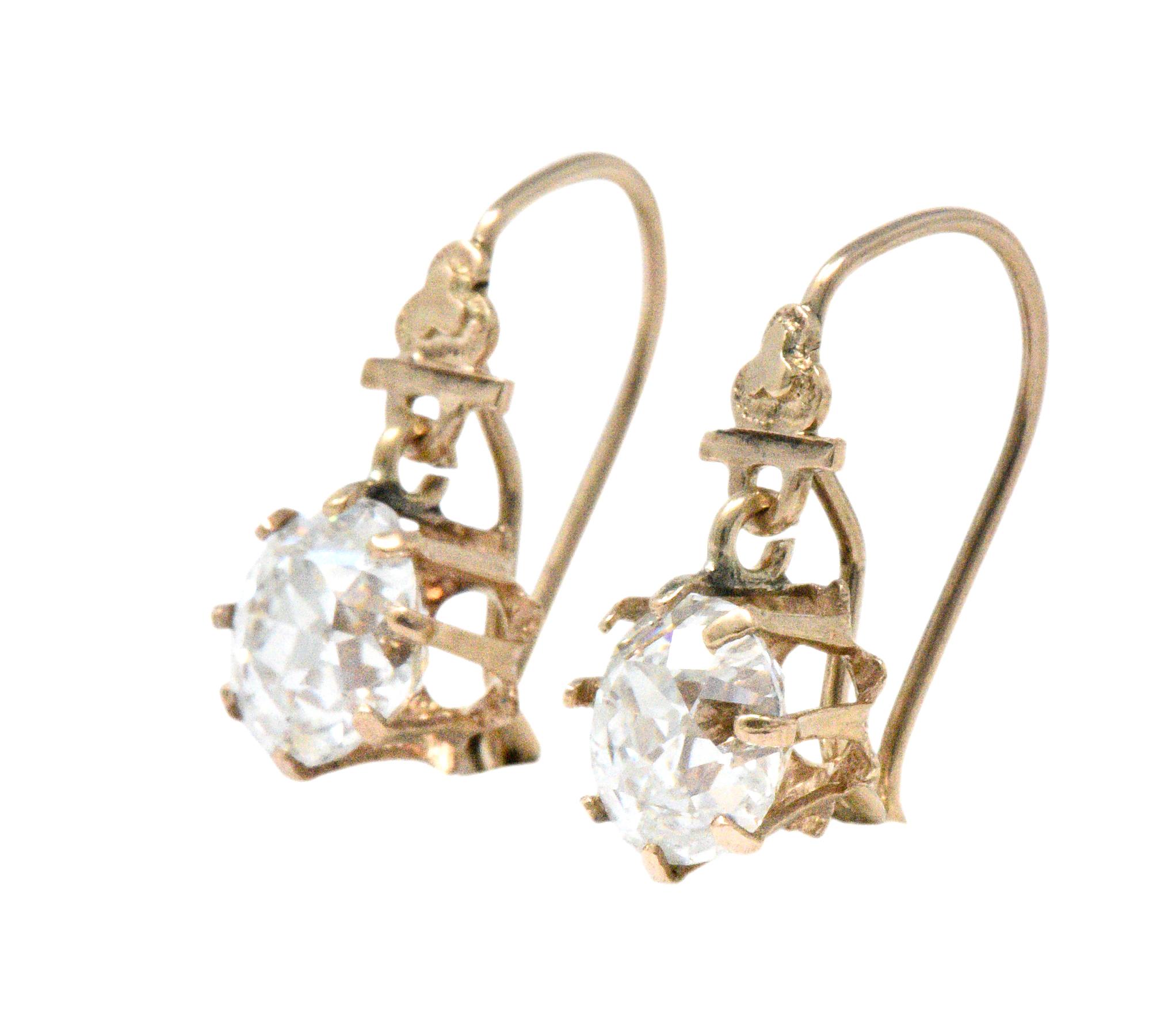 Each set with an old mine cut diamond weighing 1.00 carats, H color, VS2 clarity and 1.08 carats, H color and VS1 clarity

Diamonds are encased in articulated eight prong heads

Drop style with hooked ear wires

Tested as 10 karat rose gold

Length: