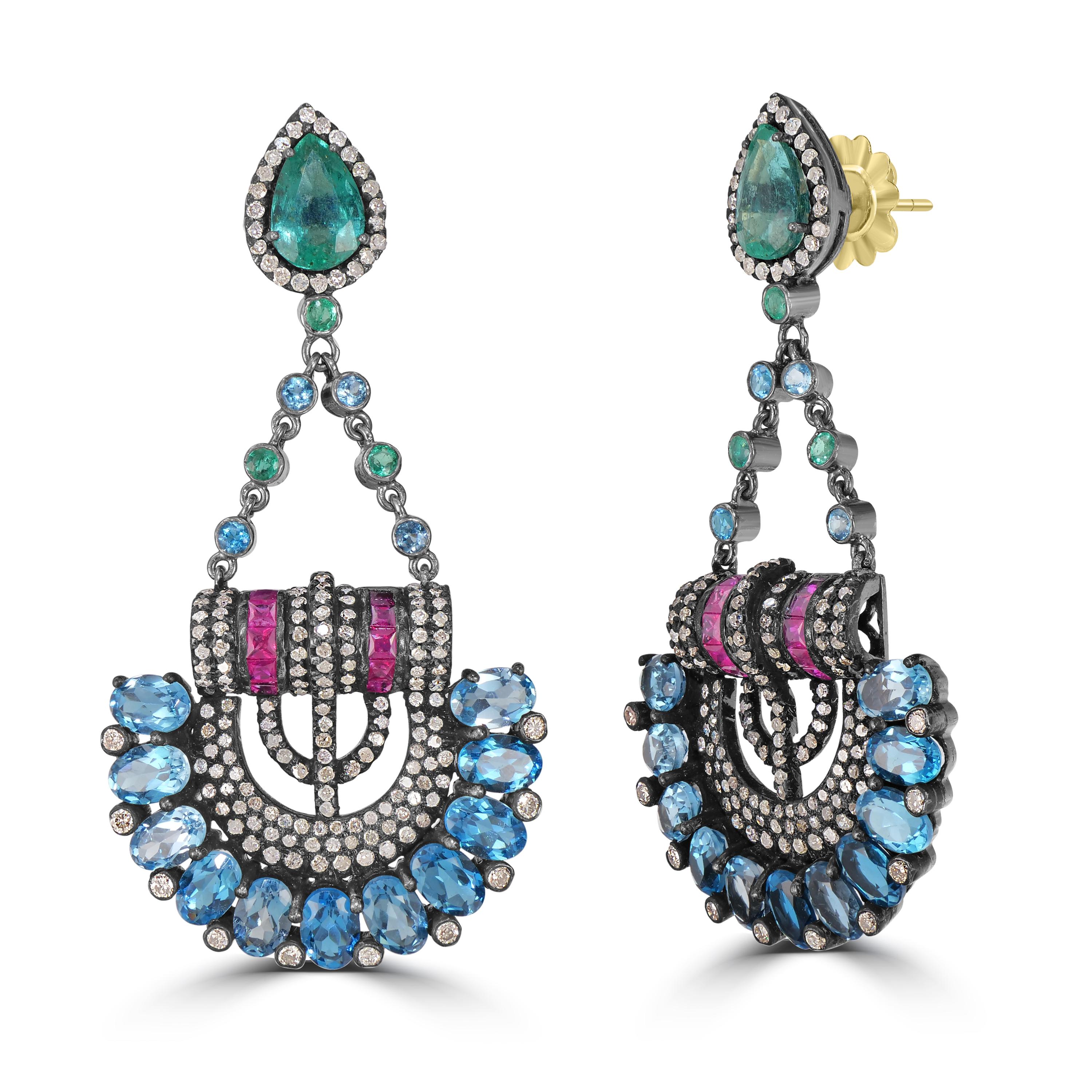 Presenting our Victorian 20.86 Cttw. Emerald, Ruby, Blue Topaz, and Diamond Dangle Earrings – a mesmerizing symphony of colors and elegance.

Designed like a hanging cradle, these earrings showcase meticulous craftsmanship and an exquisite