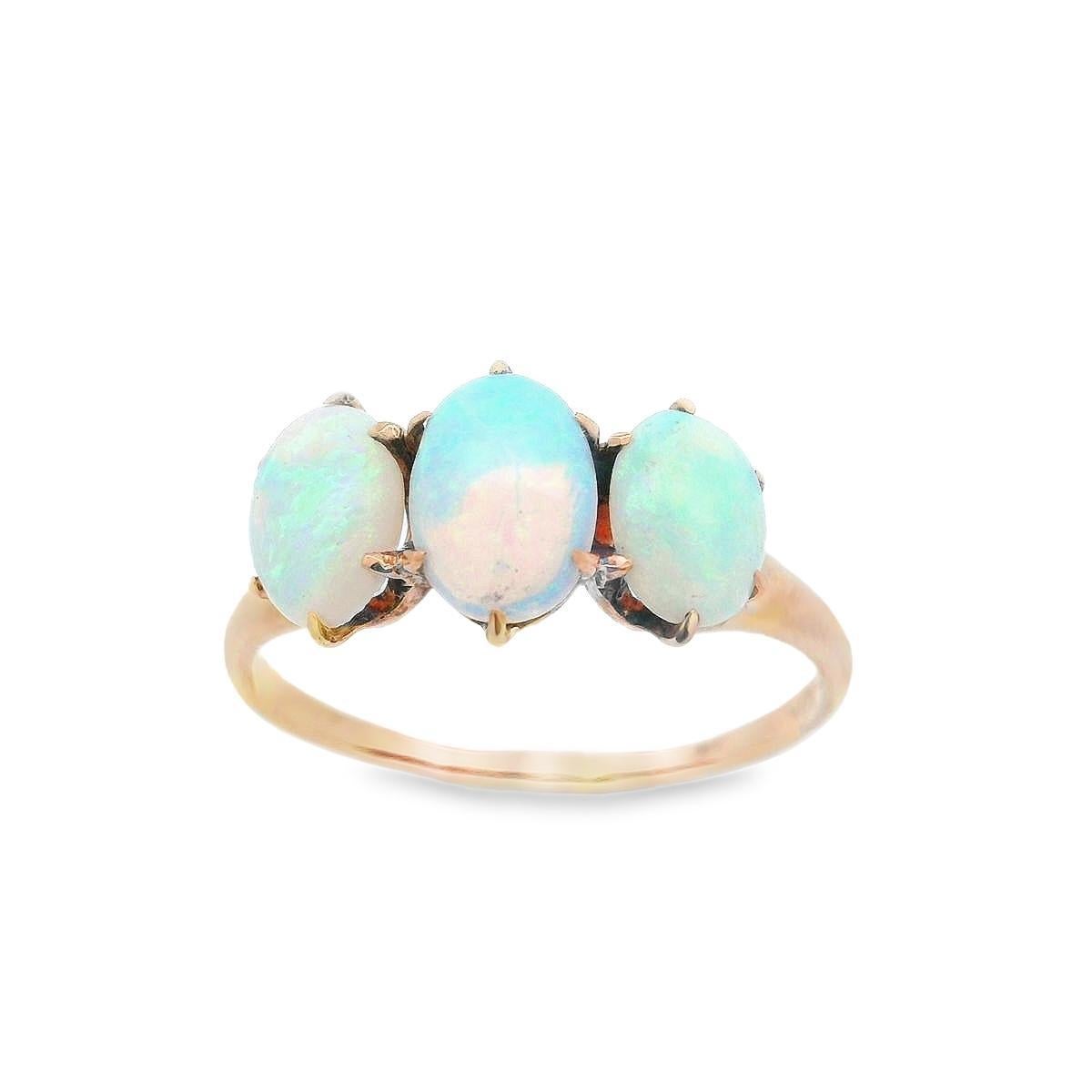 This lovely Victorian 3 stone ring is made in 10k yellow gold with natural opals from the 1890s. The opals boast beautiful range of vivid hues with great play of color: old shades of clear blue, vivid striking green and bright orange. Each opal is