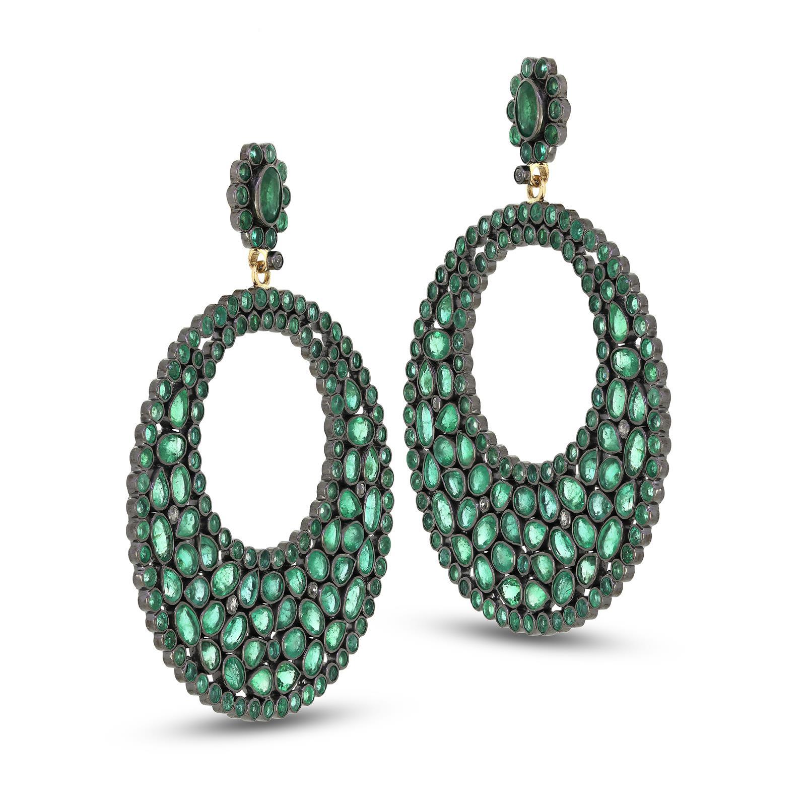 Deck out your earlobes in these majestic Emerald Circle drops. Featured with an enchanting mix of dazzling emeralds that are intricately arranged in a circular design with a smattering of diamonds in between and are mounted on 18k/925 sterling