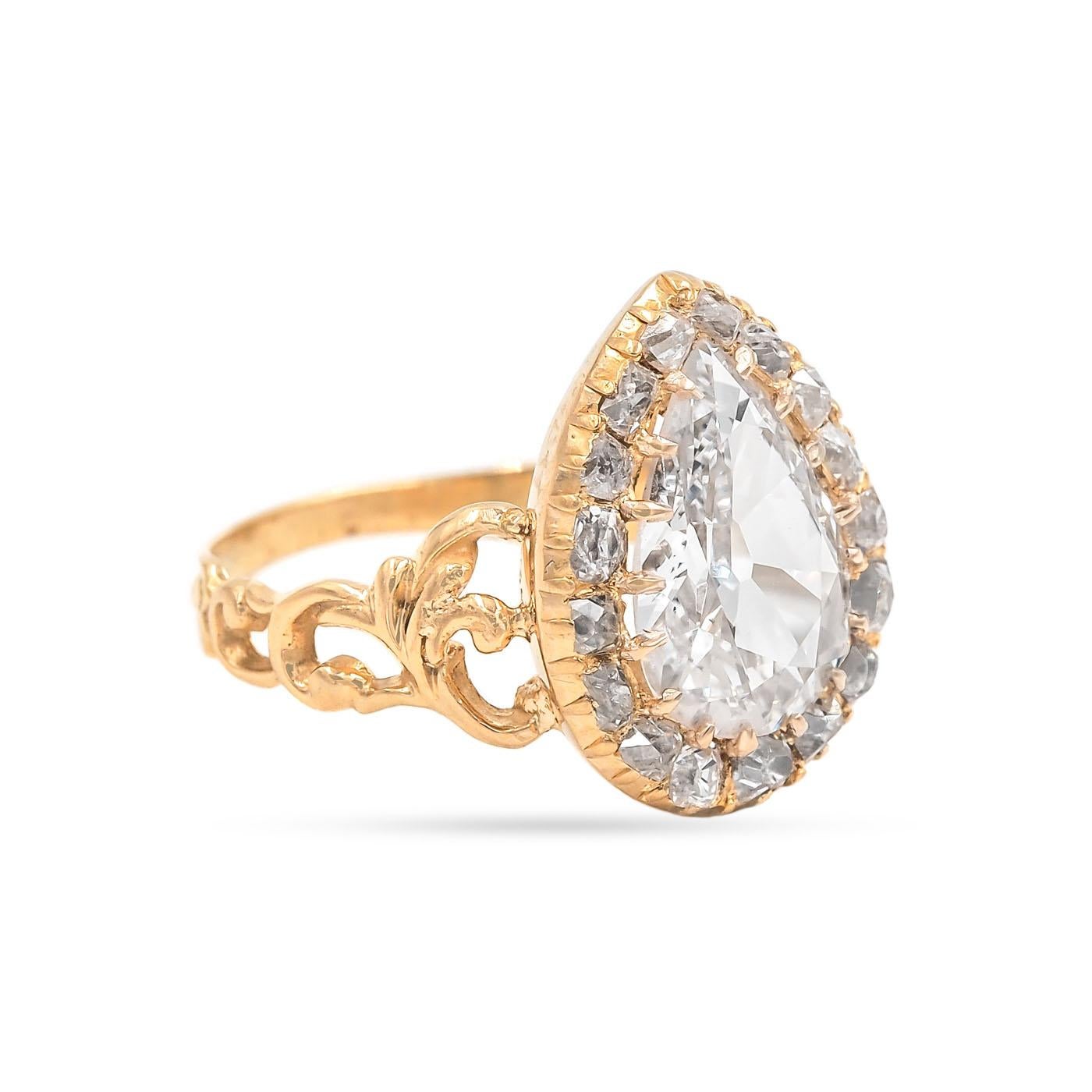 Victorian era 2.15 Carat Antique Pear Cut Diamond Ring composed of 18k yellow gold. GIA Certified 
G color/SI2 clarity. Surrounded by an additional 17 Old Mine Cut diamonds weighing approximately 0.50 carats in total. Circa 1850. Beautiful scroll