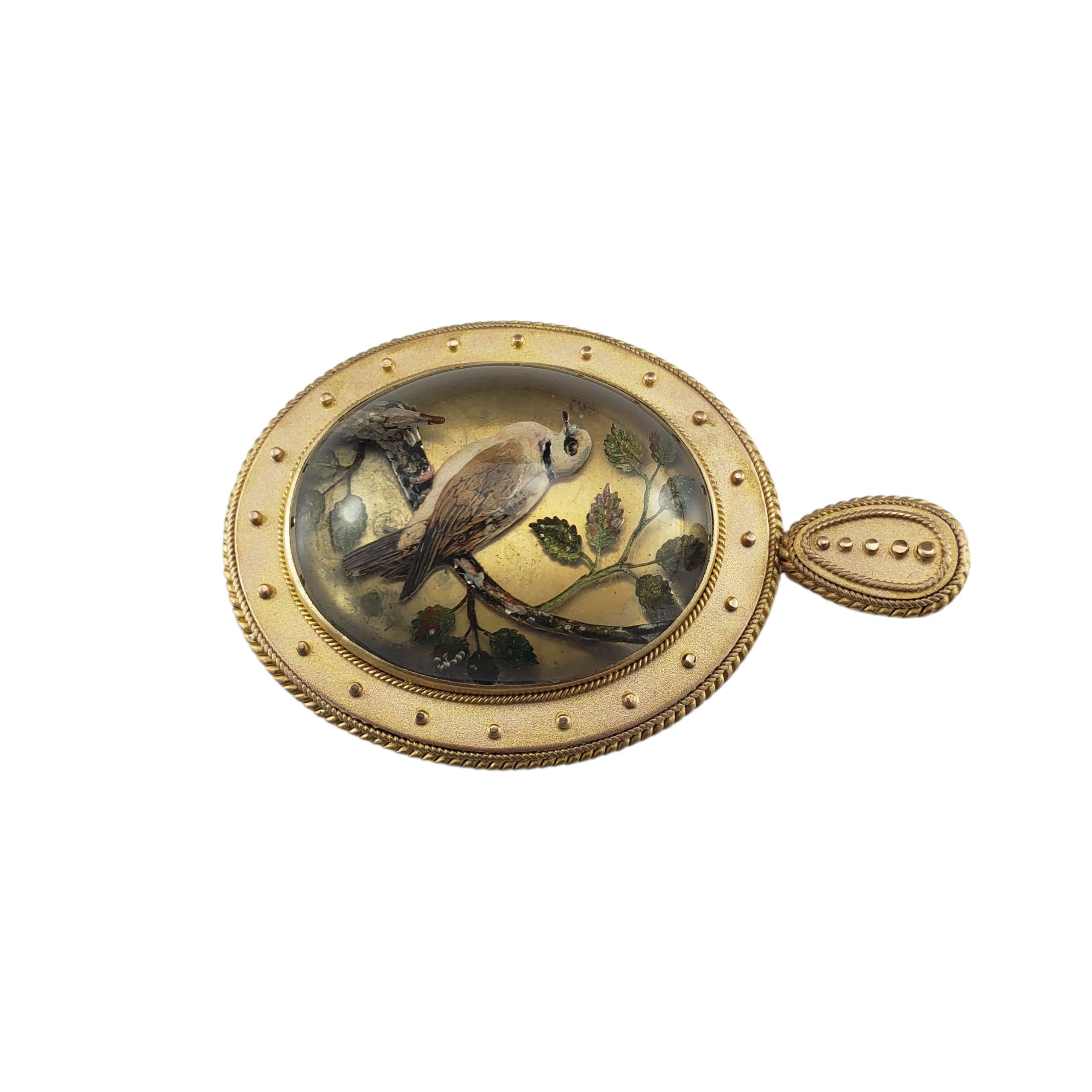Victorian 21K Yellow Gold Reverse Intaglio Essex Glass Pendant-

This exceptional reverse intaglio glass pendant is set in beautifully detailed 21K yellow gold and is reverse painted to depict a finely detailed bird perched on a branch. This rare