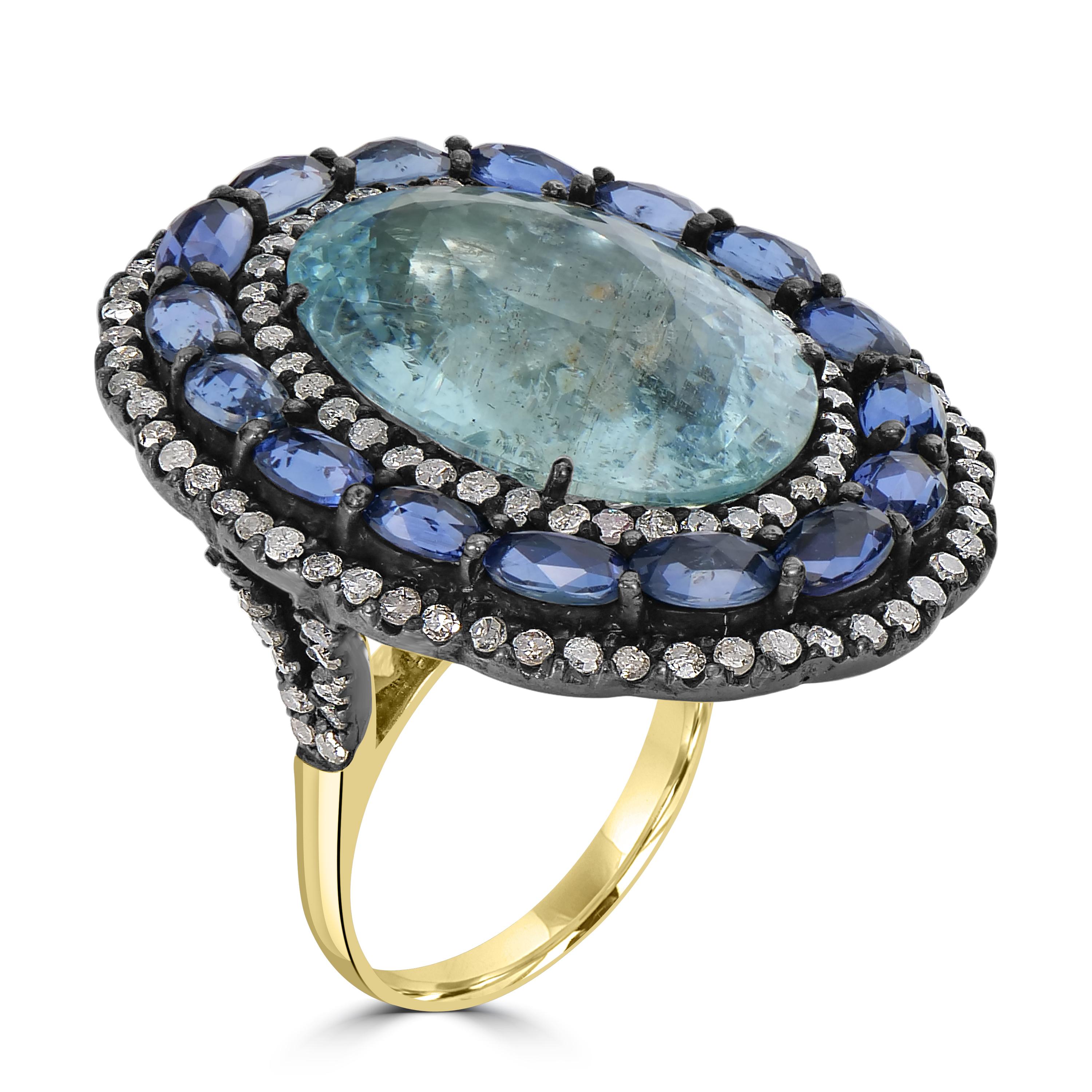 Step into a world of opulence with the Victorian 22 Cttw. Aquamarine, Sapphire, and Diamond Split Shank Cocktail Ring — a dazzling embodiment of sophistication and style. At its core, a resplendent 16-carat oval aquamarine takes center stage,