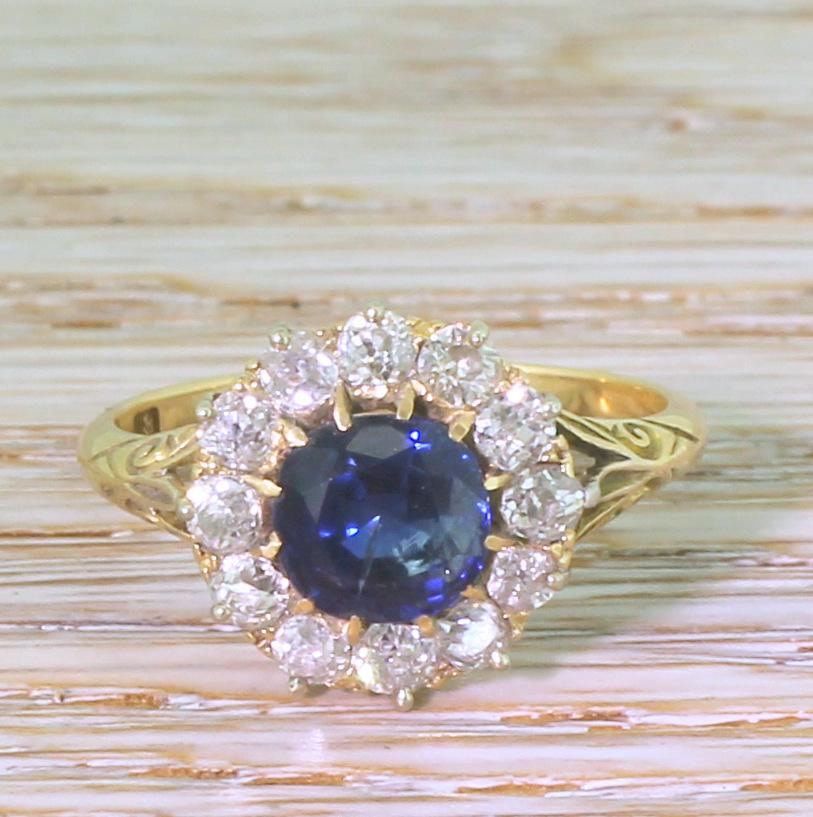 A truly wonderful antique sapphire and diamond ring. The centre stone – certified as natural and with no heat treatment – is a rich, deep blue and is surrounded by twelve white and bright old mine cut diamonds in a coronet setting. Beautifully