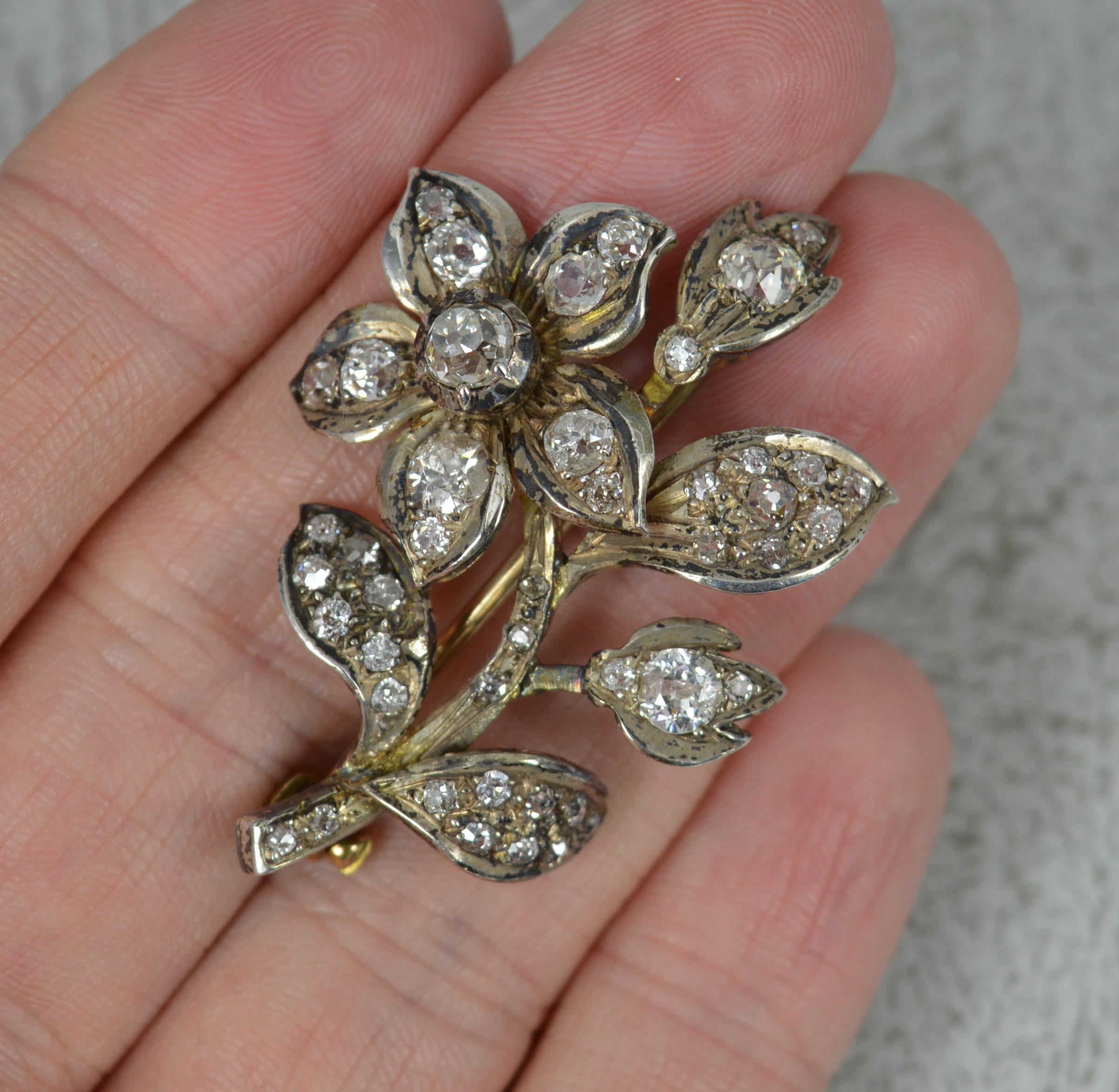 A stunning mid Victorian era brooch.
Solid 15 carat gold example with silver head setting.
Designed as a flower, forget me not shape. Encrusted with natural old mine cut diamonds throughout. Some wonderful, deep cuts. Minimum 2.2 carats. Averaging