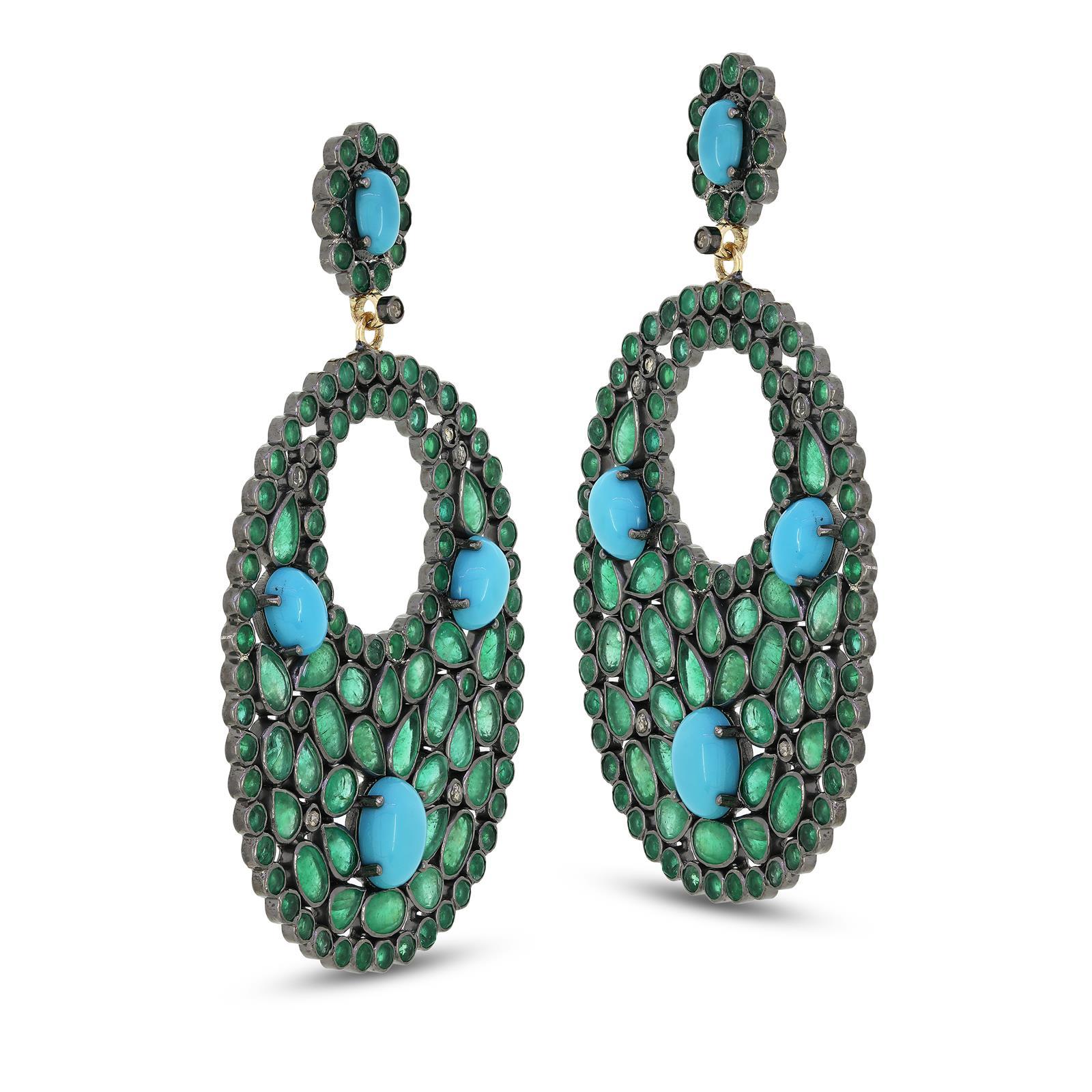 Deck out your earlobes in these majestic Victorian Emerald, Turquoise and Diamond drops by Gemistry. Featured with an enchanting mix of dazzling emeralds that are intricately arranged in a circular design accentuated by three oval cabs of turquoise