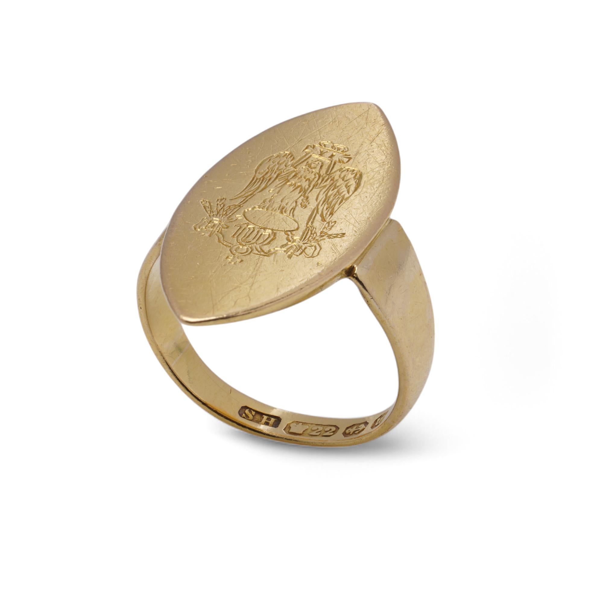 A substantial Victorian signet ring crafted in 22K yellow gold. The ring features an elongated, navette-shaped face engraved with a heraldic crest, possibly representing nobility or familial heritage.
The engraving on the signet ring depicts a