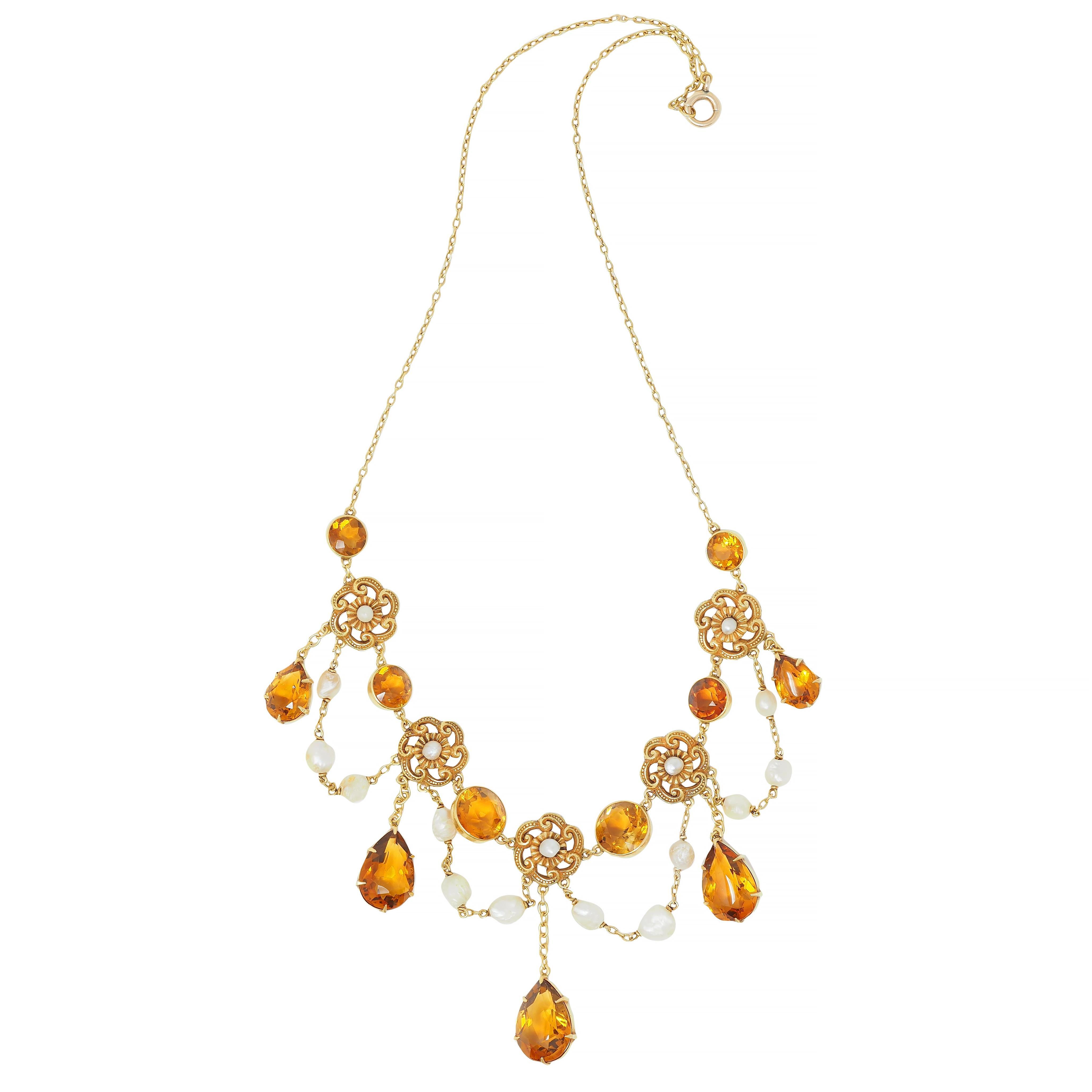 Comprised of cable link chain with a swagged central station with fringe drops
Featuring graduated round cut citrine stations bezel set across 
Weighing approximately 8.52 carats total - transparent medium brownish orange
Alternating with pierced