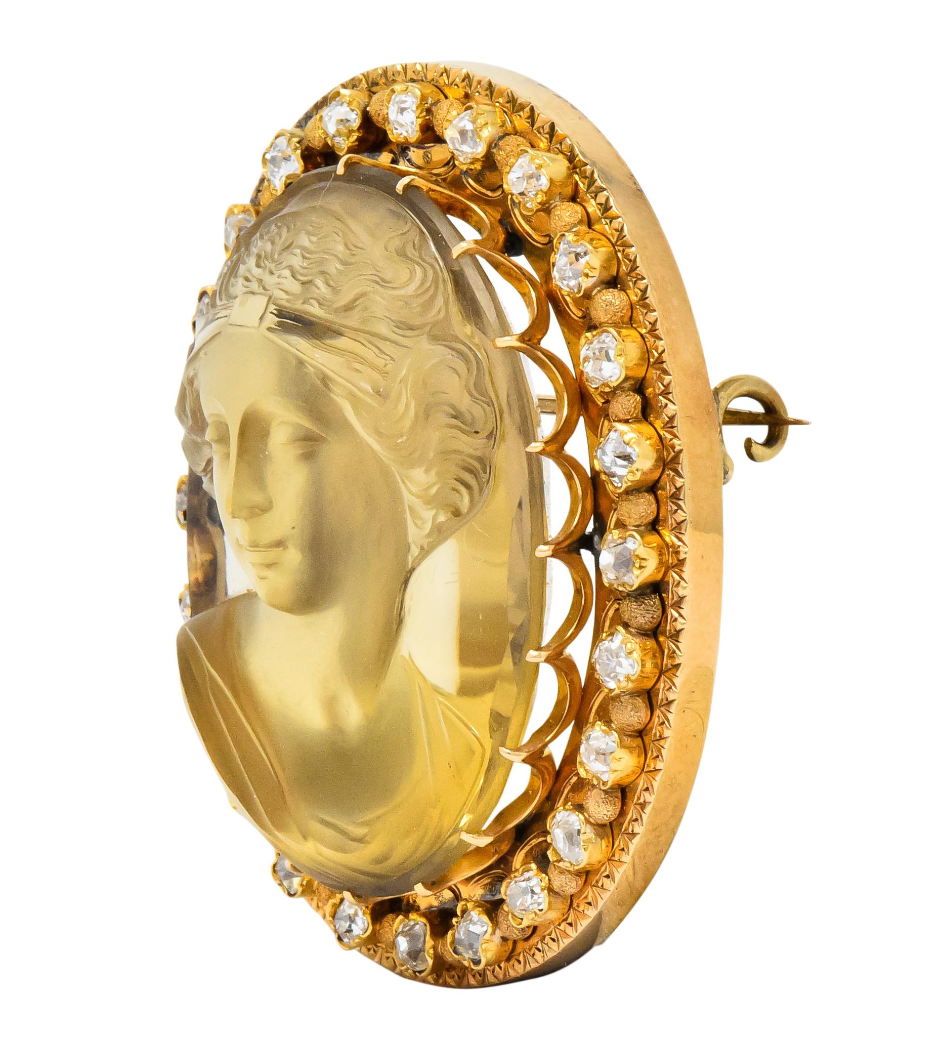 Centering a carved citrine cameo of a front-facing lady with up-swept hair

With an old mine cut diamond surround, total diamond weight approximately 2.40 carats, GHI color and VS to SI clarity

Highly detailed carving with a high relief in a claw