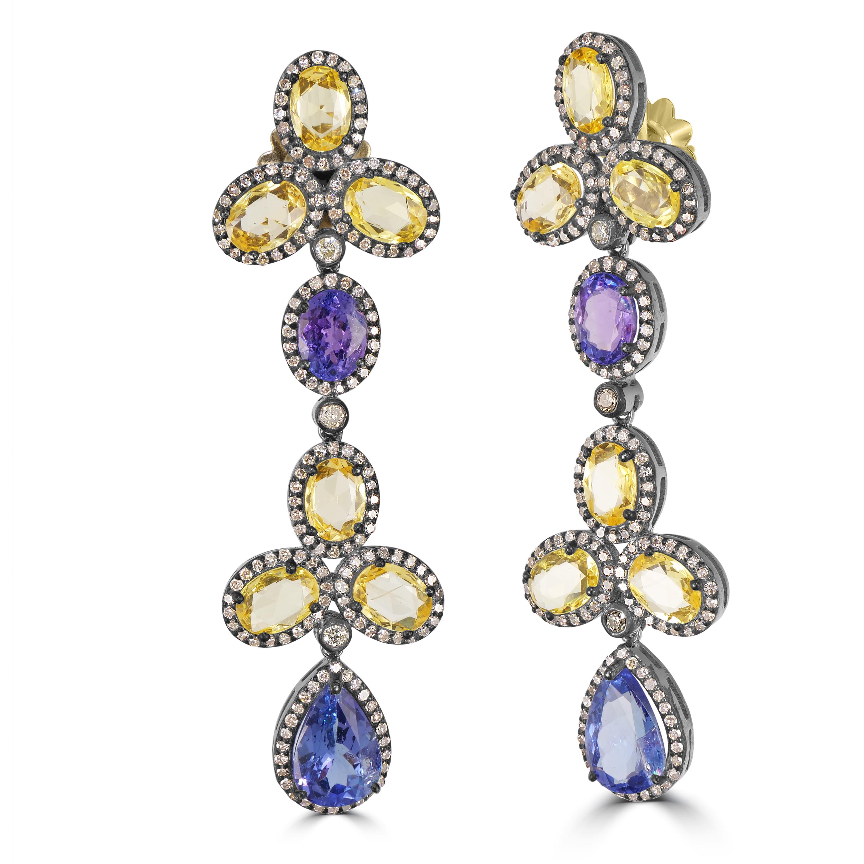 Introducing the exquisite Victorian 24.87 Cttw. Tanzanite, Yellow Sapphire, and Diamond Dangle Earrings—a masterpiece that seamlessly blends elegance with a touch of vibrant luxury.

At the heart of these earrings are three leaf clovers, crafted