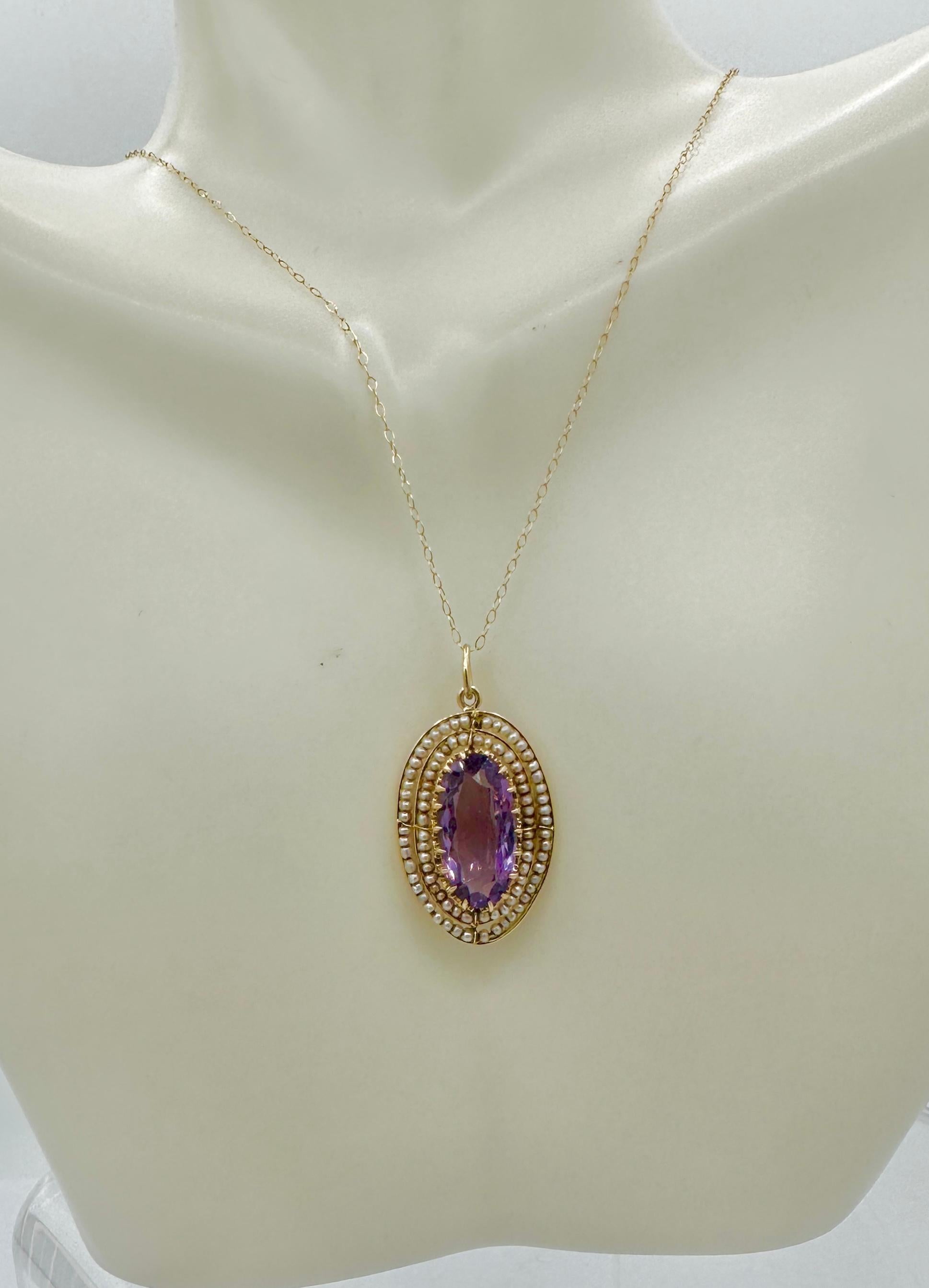 THIS IS A STUNNING VICTORIAN EDWARDIAN 2.5 CARAT OVAL FACETED AMETHYST AND PEARL LAVALIERE PENDANT WITH THE MOST GORGEOUS NATURAL OVAL FACETED AMETHYST GEM SURROUNDED BY TWO LAYERS OF SEED PEARLS SET IN AN OPEN SETTING IN 14 KARAT YELLOW GOLD.  THIS