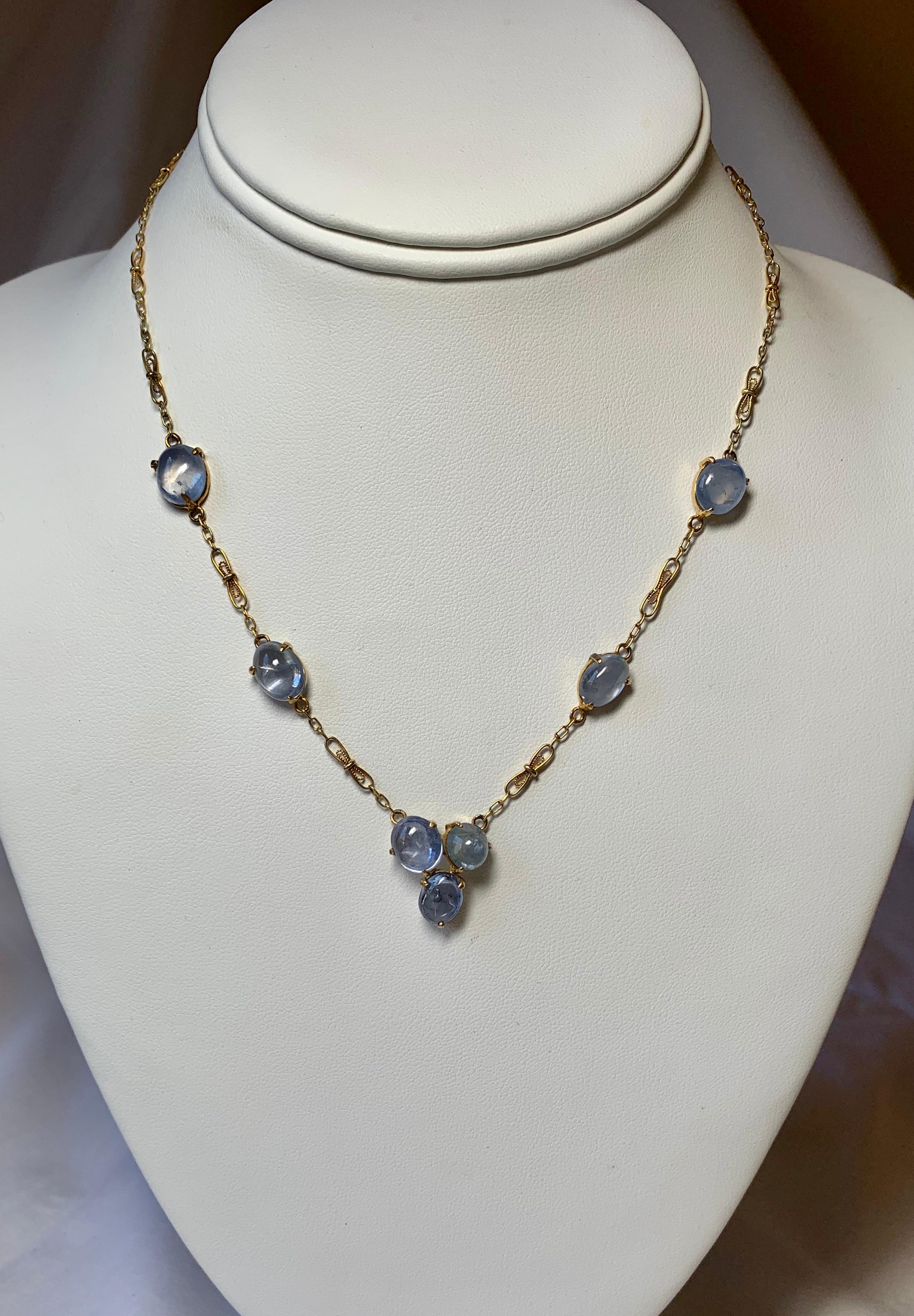 A stunning antique Victorian - Edwardian Sapphire Necklace with a gorgeous Fetter Link Chain in 14 Karat Gold.  This rare antique necklace features 7 fine blue natural mined Sapphire gems.  The sapphires are cabochon cut oval gems.  Each sapphire is