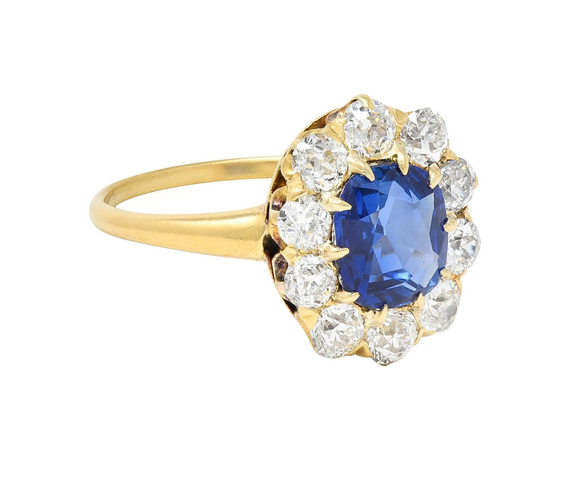 Centering a cushion cut sapphire weighing 1.58 carats - transparent medium blue in color 
Natural Kashmir in origin and displaying no indications of heat treatment
Set by talon prongs with a halo surround of old European cut diamonds
Weighing