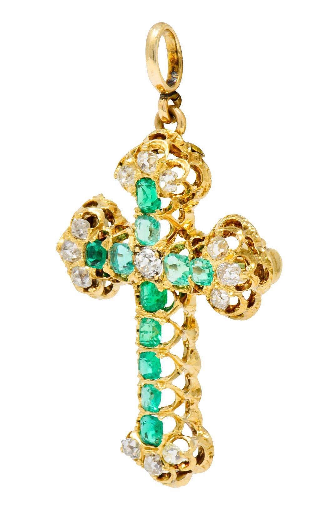 Pendant brooch designed as a cross with ornate pierced scalloped gallery

Each arm of cross is set with a row of consecutive square step cut emeralds weighing approximately 1.32 carats; transparent and green to light green in color

Each arm