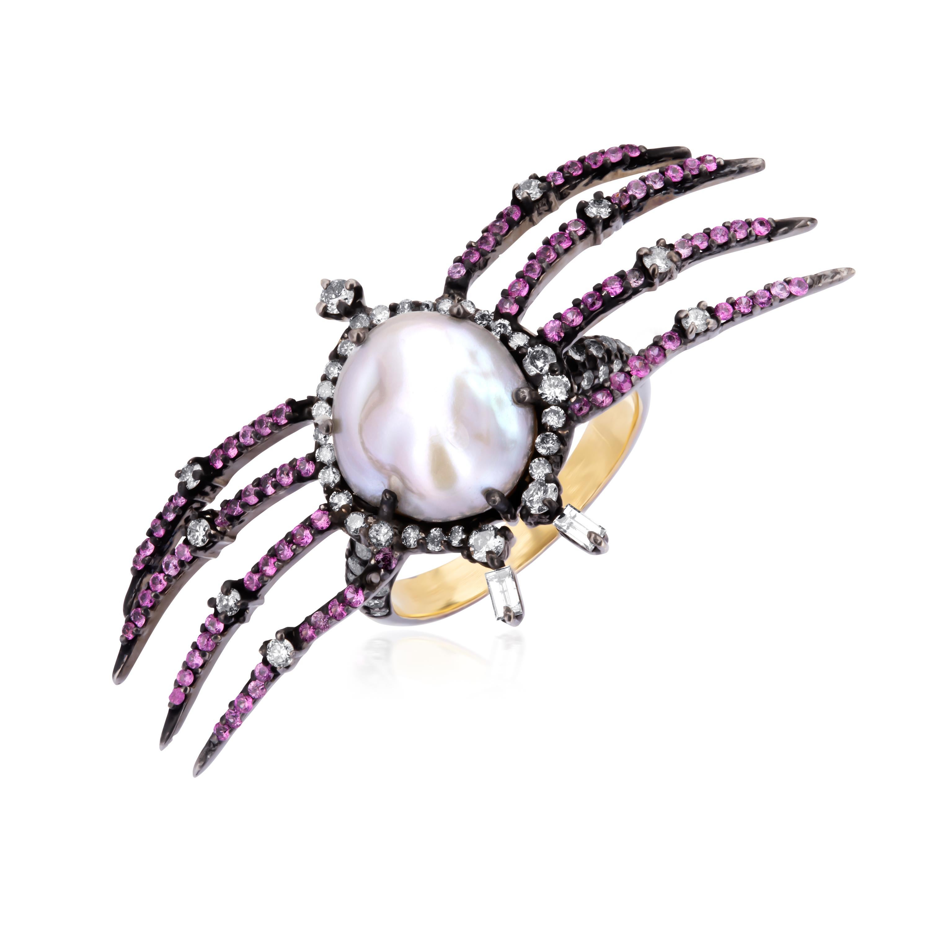 This classic Victorian ring showcases a crafty arachnid alighted with a satiny pearl at the center accentuated with pink sapphires and diamonds (IJ Color, SI Clarity) adorning it's legs. Rendered in 18K gold this whimsical ring, is the perfect match