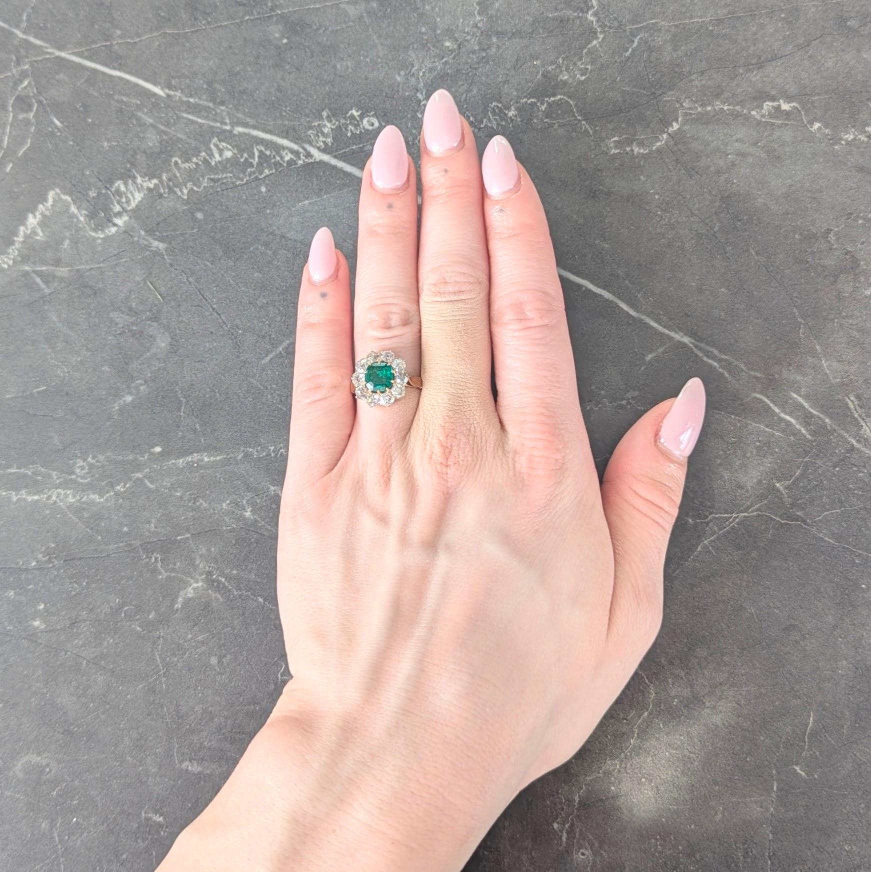 Centering a mixed step-cut emerald weighing approximately 1.09 carats total
Natural Colombian in origin with moderate clarity enhancement (F2)
Set by talon prongs with a halo surround of old mine cut diamonds
Weighing approximately 1.70 carats total