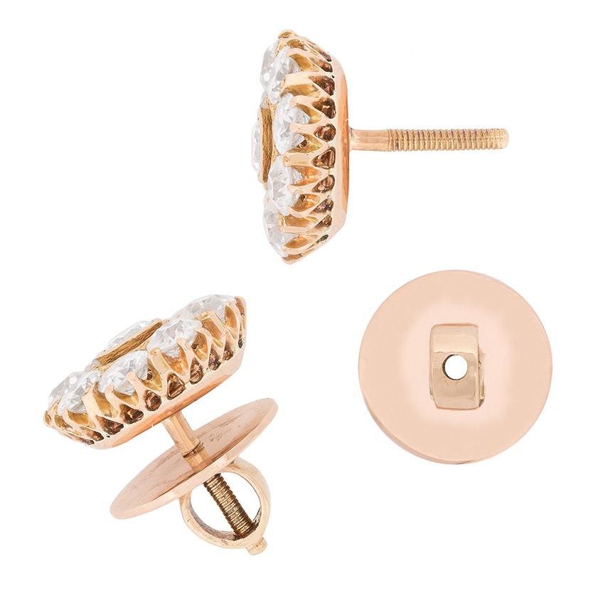 These stunning earrings are hand crafted from 18 carat rose gold. Dating back to the 1900s, they show off sparkling old cut diamonds which have been hand cut. Each earring has a combined weight of 1.40 carat, with the centre diamond weighing 0.20