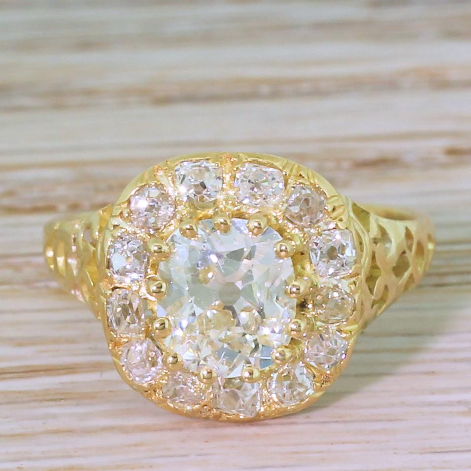 A Victorian old cut diamond ring of phenomenal beauty. At the centre is an impressively bright 1.50 carat old cut – certified by EGL as I colour, VS1 clarity – claw set within a surround of thirteen further old mine cuts. The stunningly and