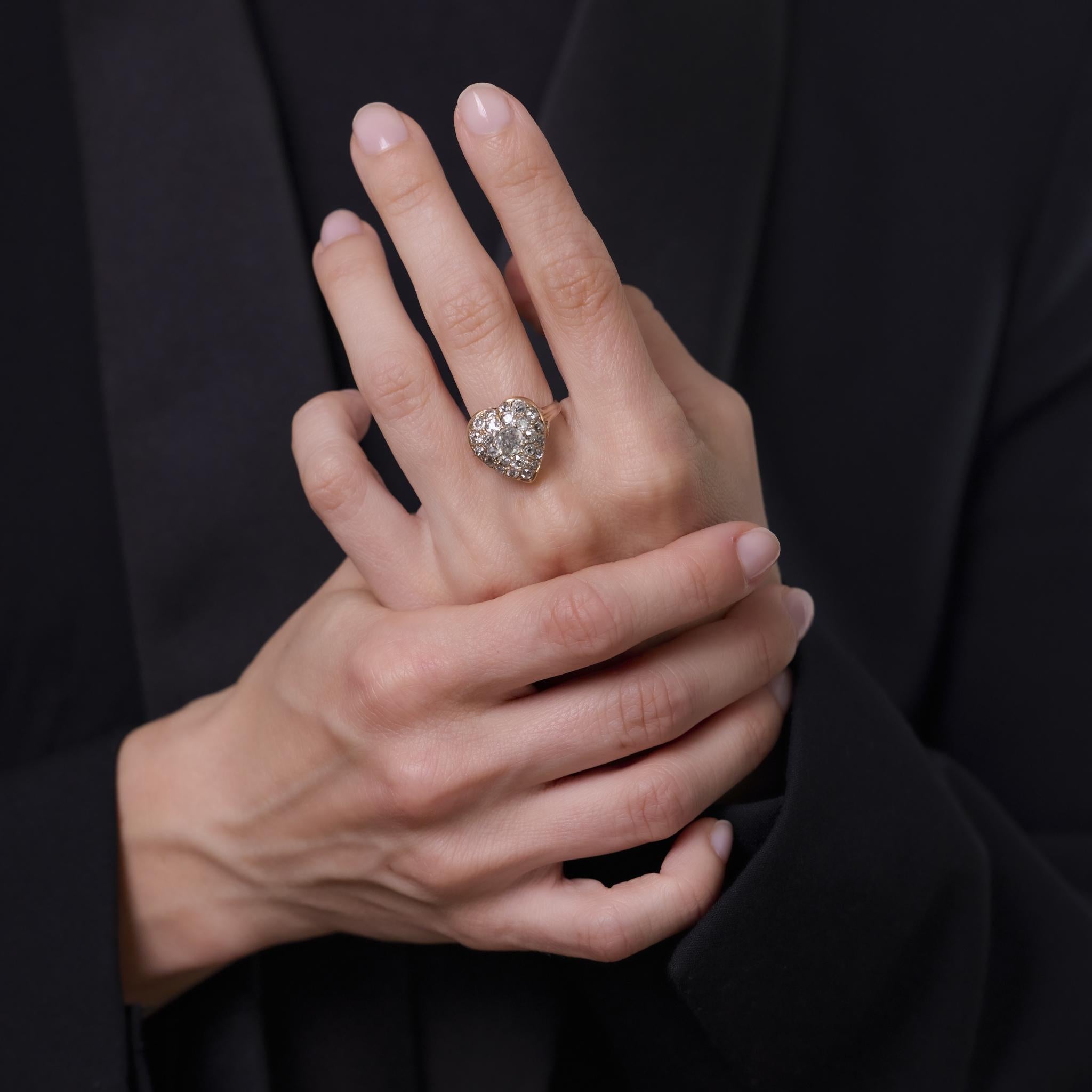 This enchanting Victorian ring showcases a lively .85 carat old mine cut diamond surrounded by a glittering halo of antique diamonds. Crafted in 14k yellow gold and silver, it radiates the romance and craftsmanship of the early 1900s.