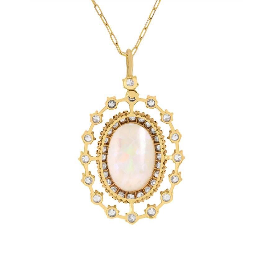 This wonderful antique pendant has a cabachon cut Opal centre stage. It has a weight of 3.00 carats and is claw set within 18 carat yellow gold. It then beautifully highlighted by a selection of old cut diamonds in double halos.

There are 1.62