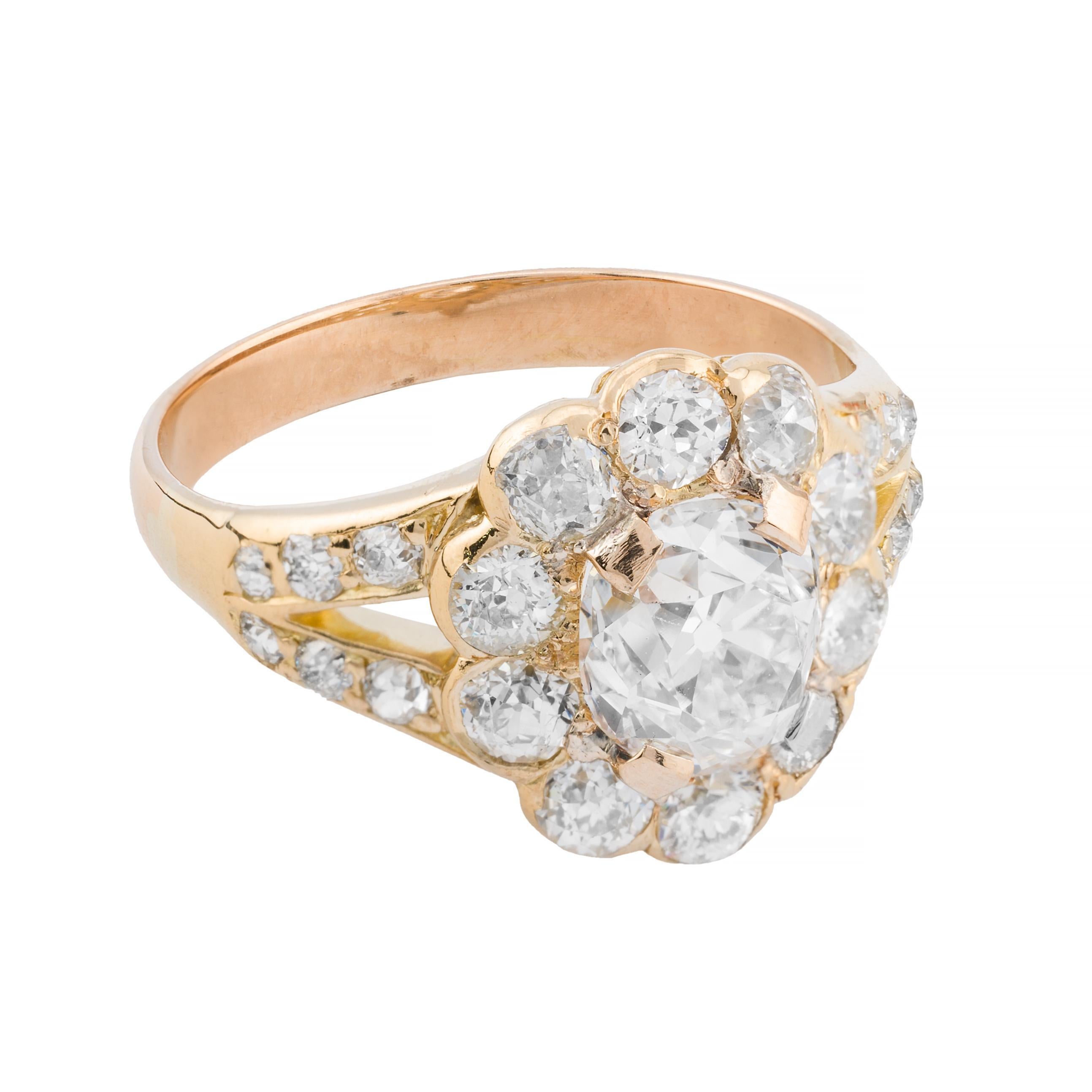 Aston Estate Jewelry Presents:

An exquisite victorian period engagement ring in 18k yellow gold. Featuring a central  cushion shaped old mine cut diamond, weighing 1.52 carats, with an H color grade and VS1 clarity. The primary stone is encircled